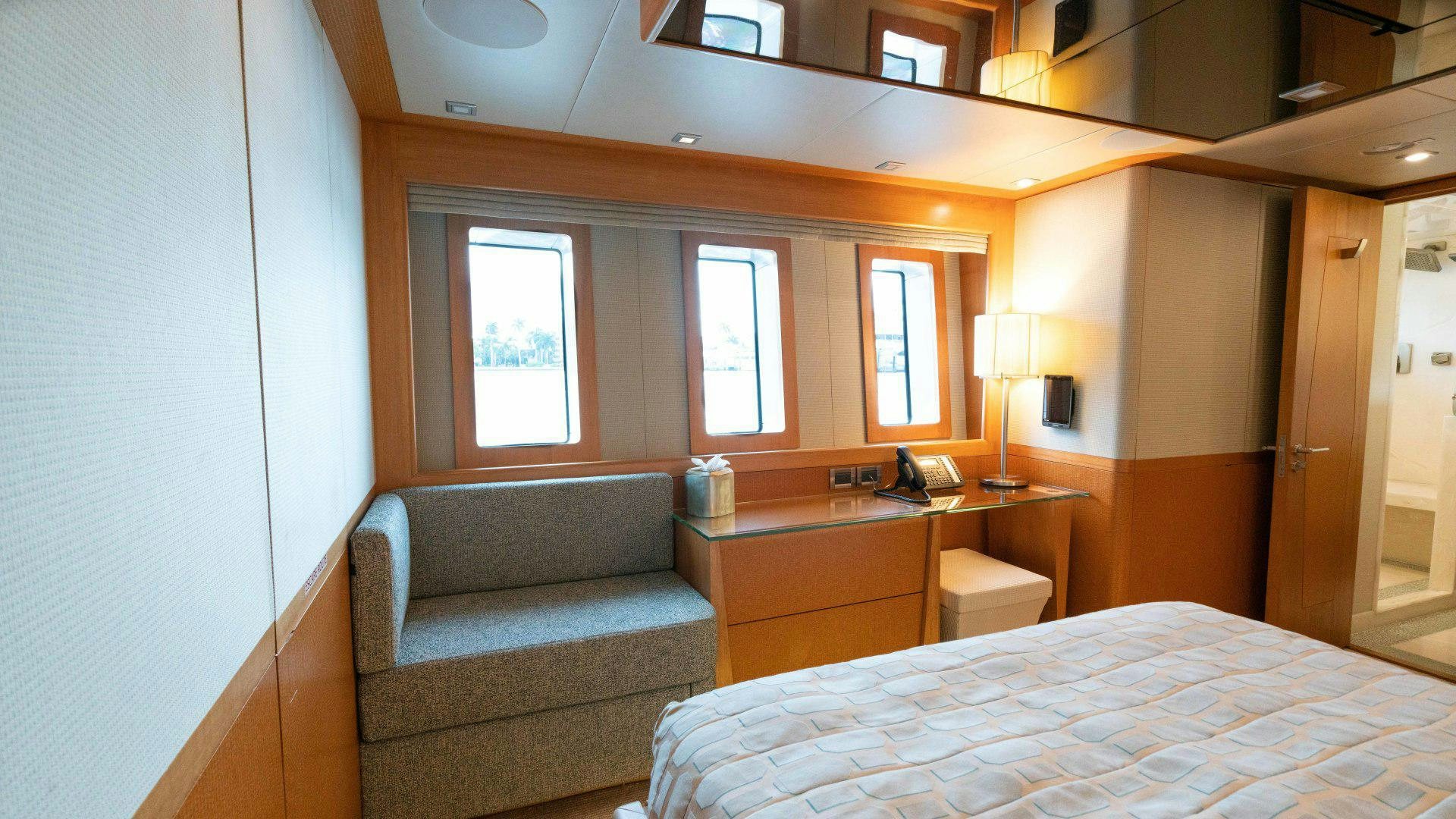 a bed and a couch in a room aboard SERENITY Yacht for Sale