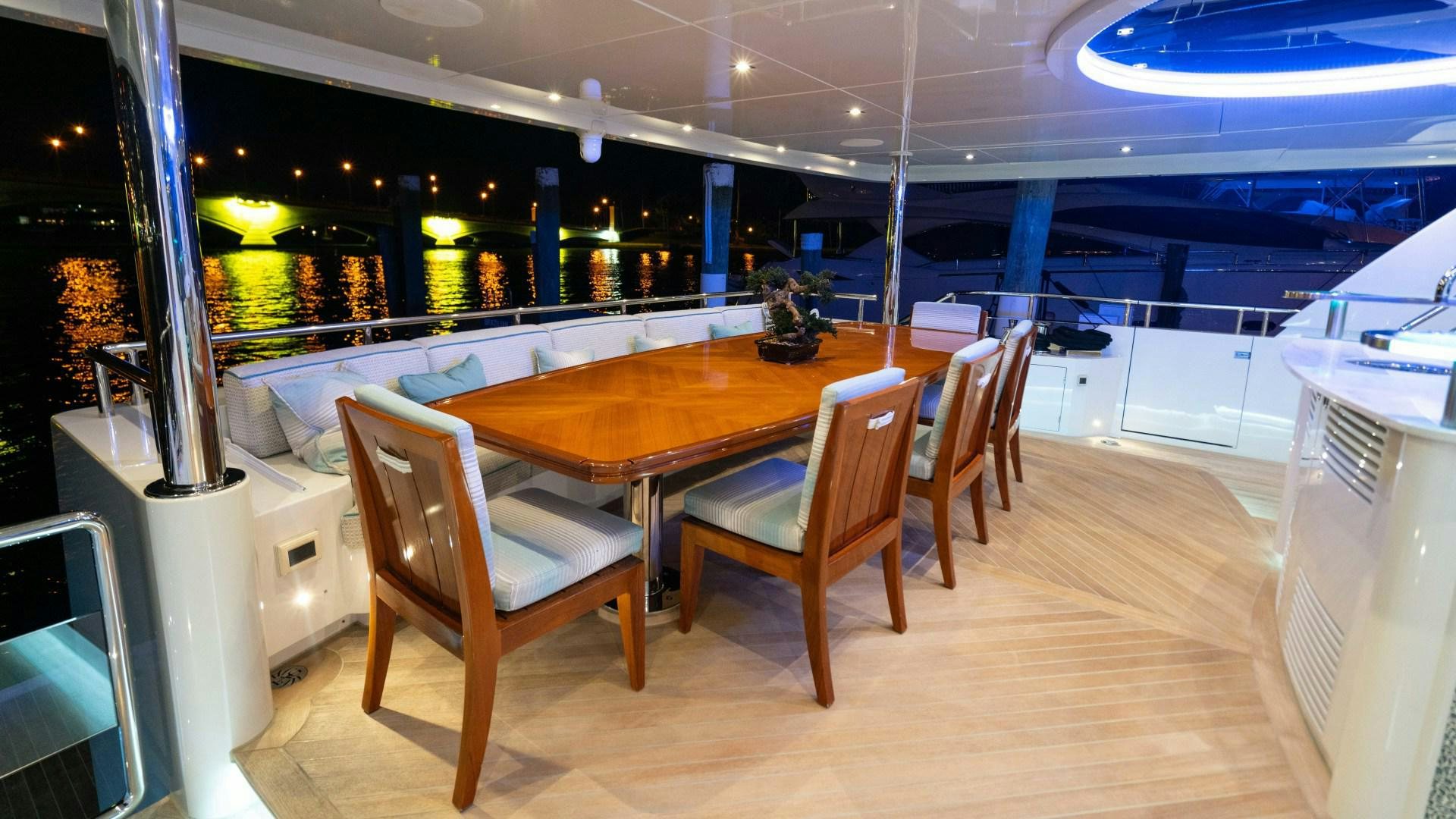 a room with a table chairs and a bench aboard SERENITY Yacht for Sale