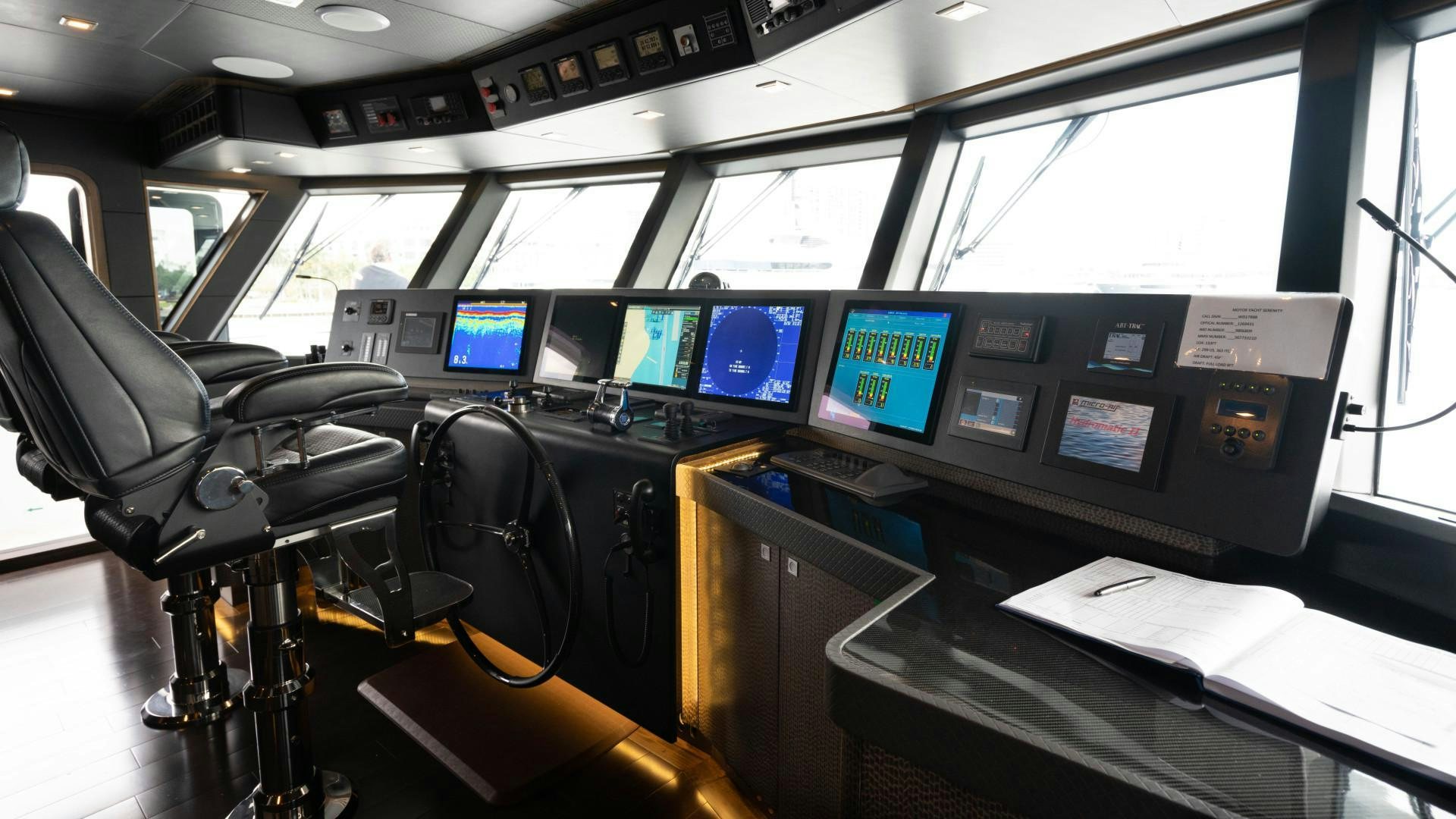 a room with many monitors and chairs aboard SERENITY Yacht for Sale