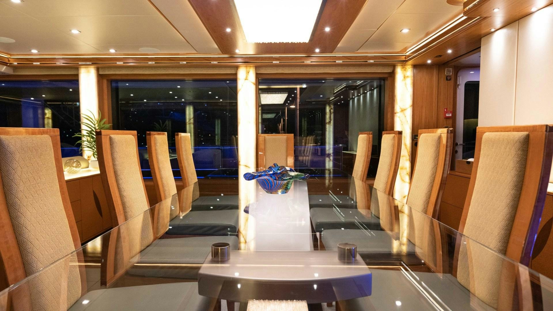 a room with chairs and tables aboard SERENITY Yacht for Sale