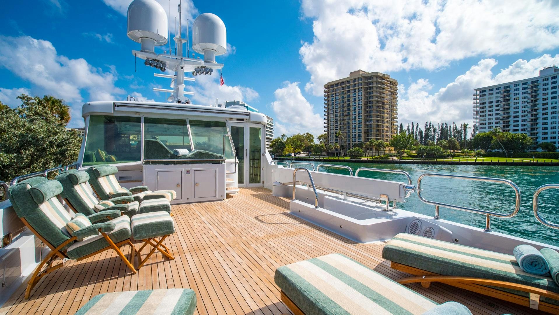 a deck with a pool and a building in the background aboard SERQUE Yacht for Sale