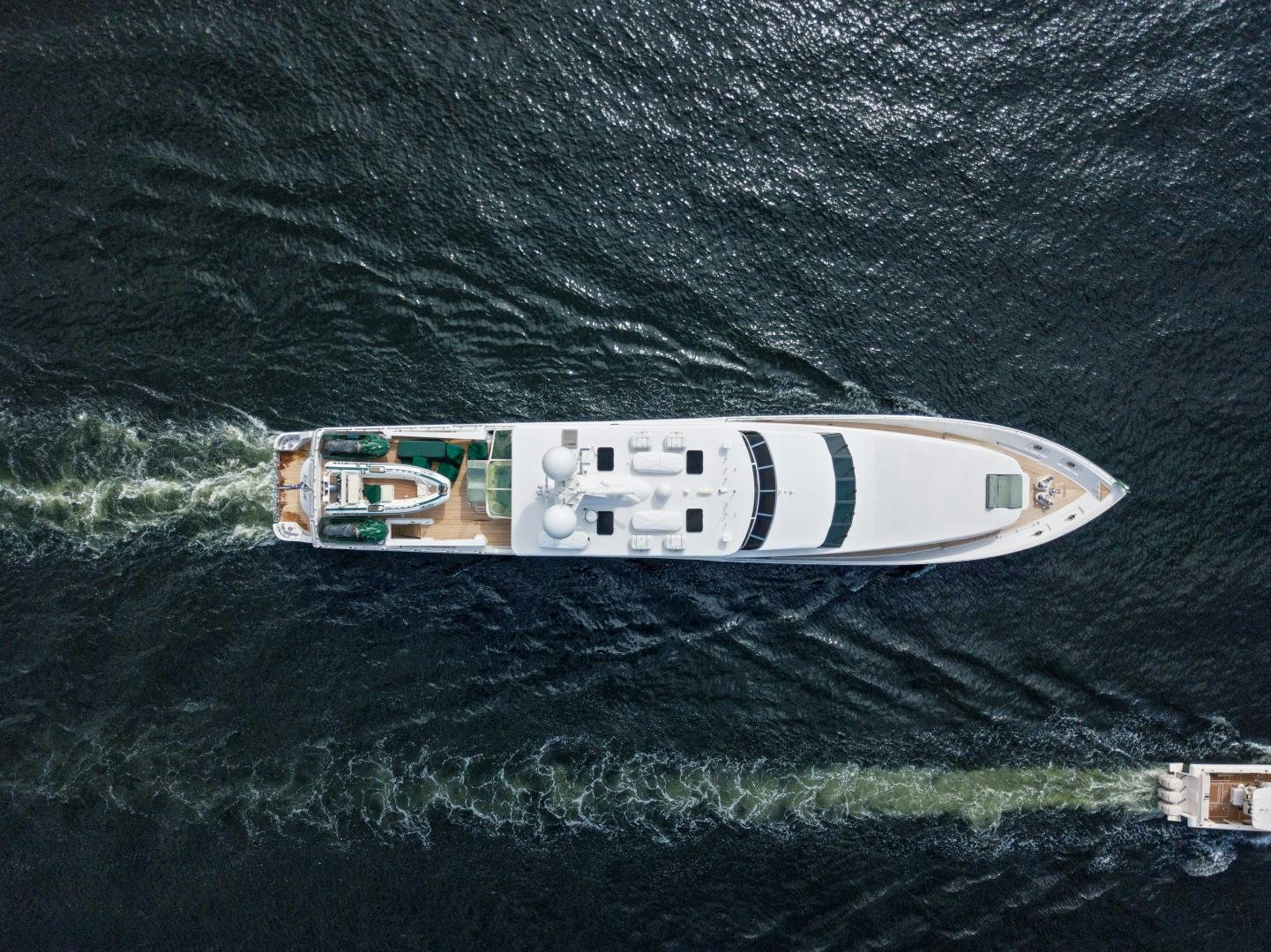 a white and green boat on water aboard SERQUE Yacht for Sale