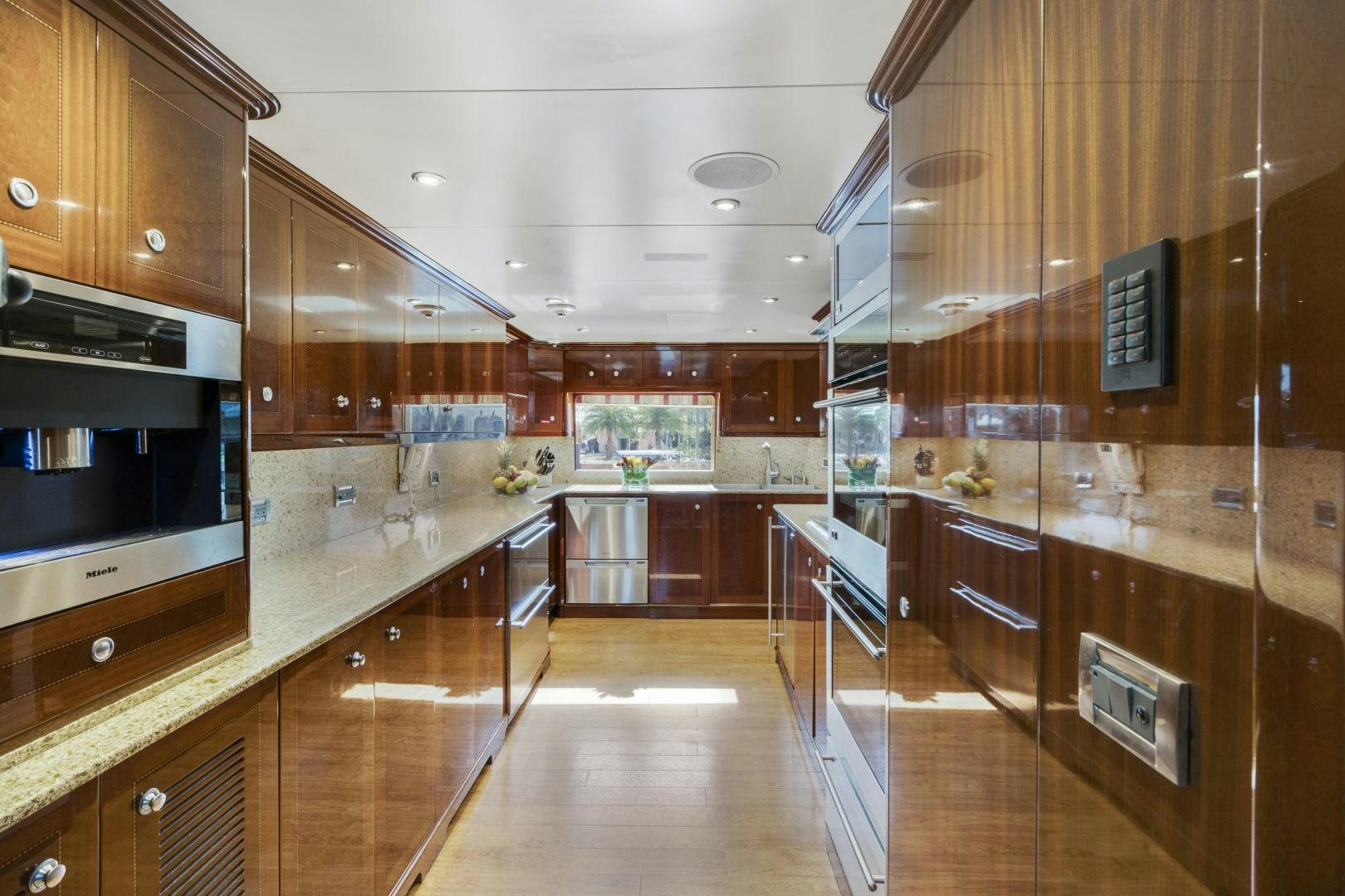 a kitchen with wooden cabinets aboard SERQUE Yacht for Sale
