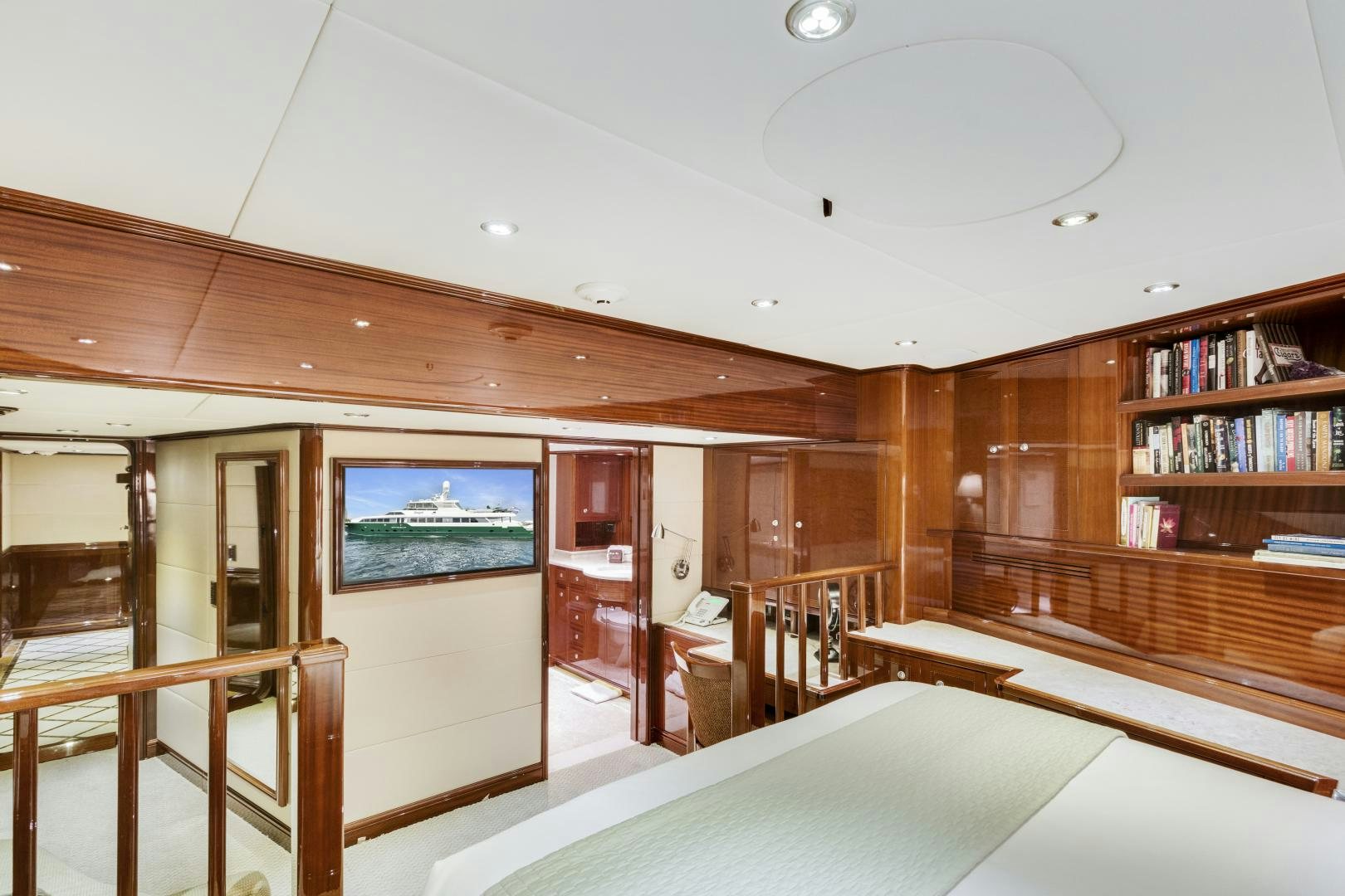 a room with a bed and a bookcase aboard SERQUE Yacht for Sale