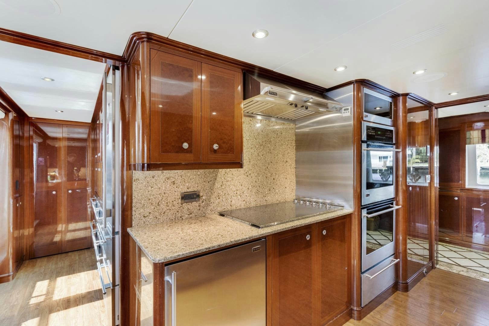 a kitchen with wooden cabinets aboard SERQUE Yacht for Sale