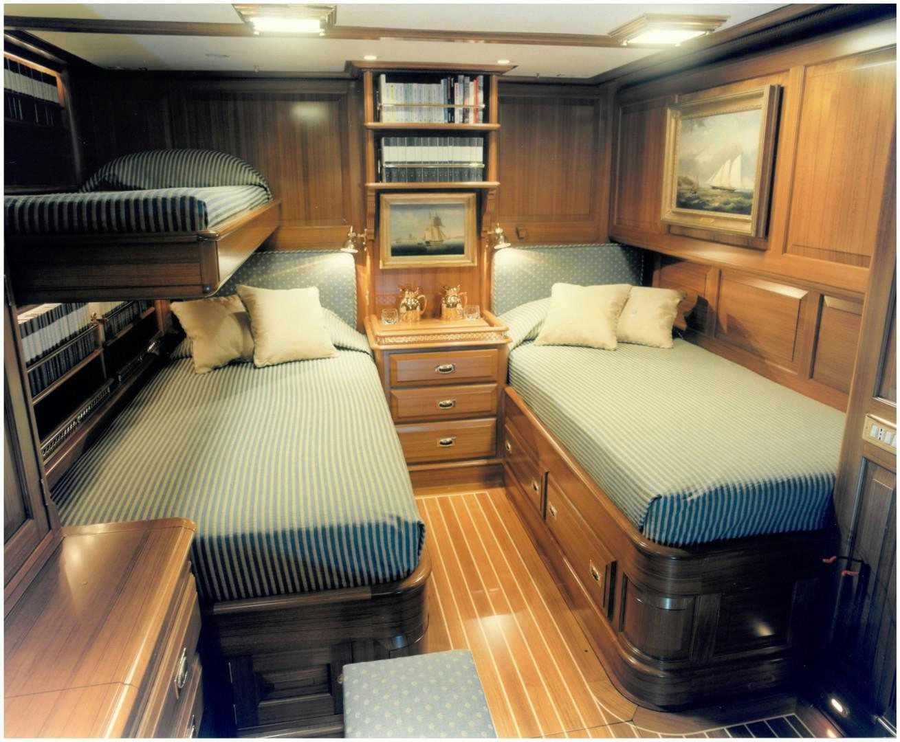 a room with a bed and a bookcase aboard ANAKENA Yacht for Sale