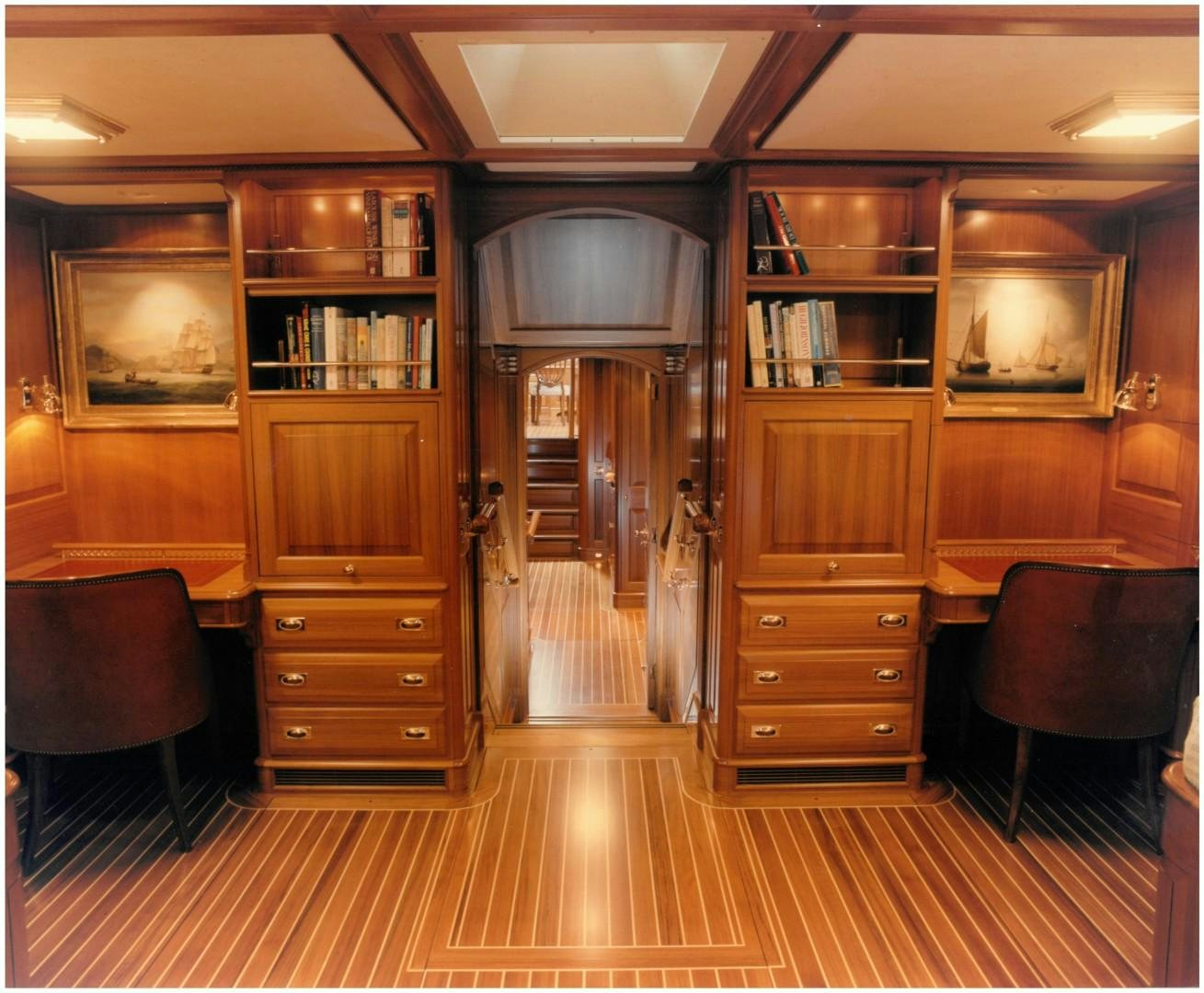 a room with a wood cabinet and a chair and a desk aboard ANAKENA Yacht for Sale