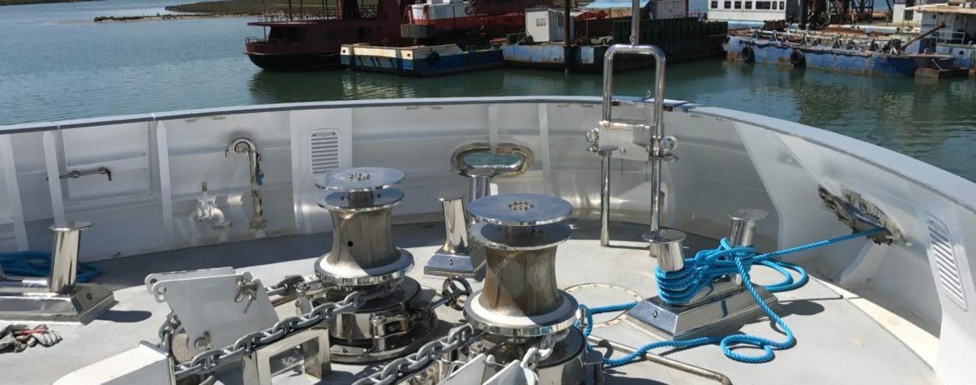 a large white boat with a blue line on it aboard NO NAME Yacht for Sale