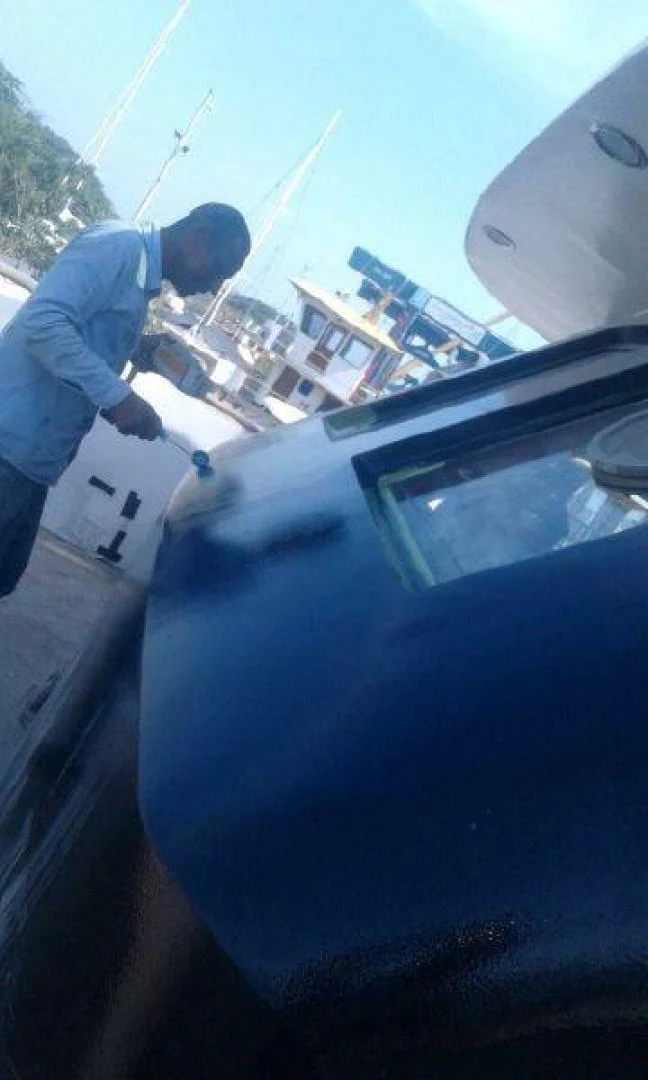 a person cleaning a car aboard STAR ALLIANCE Yacht for Sale