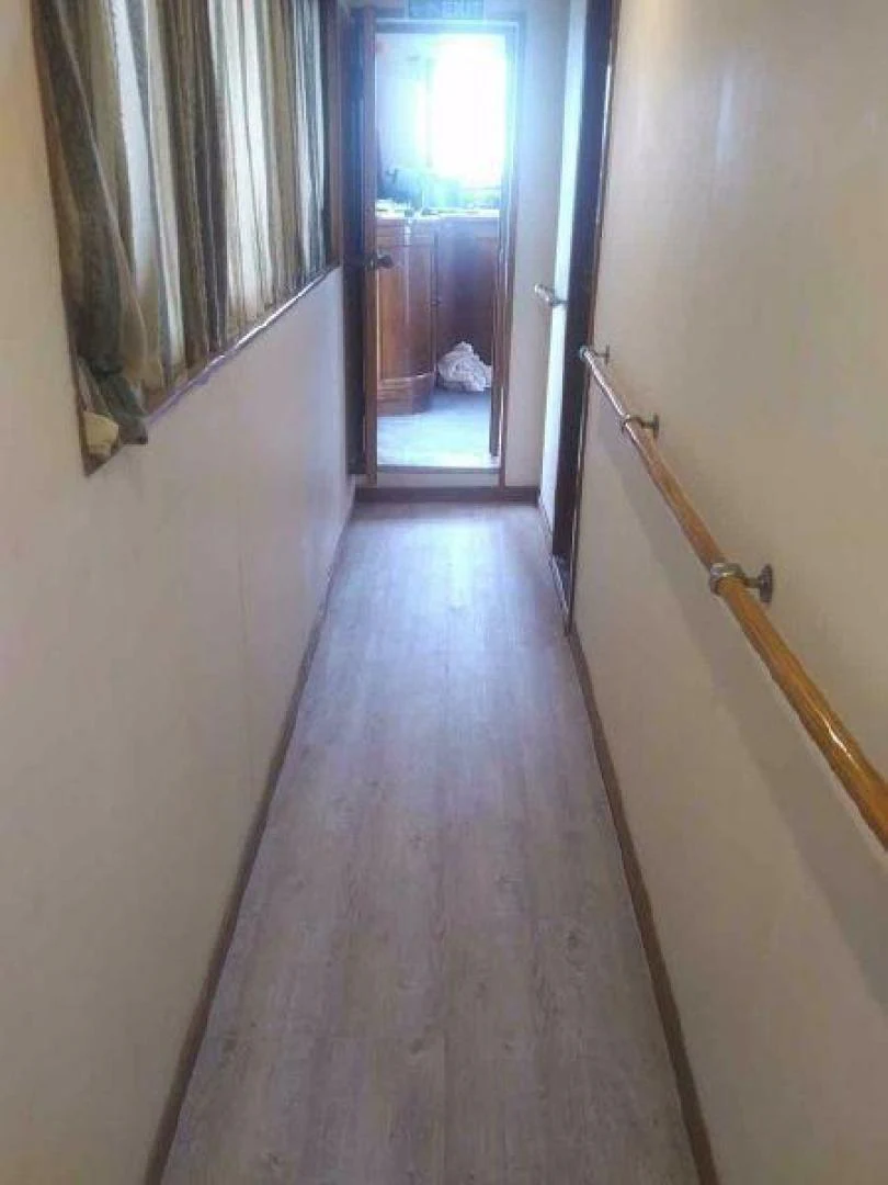 a hallway with a door and a window aboard STAR ALLIANCE Yacht for Sale