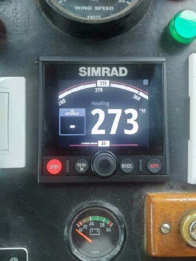 a digital clock on a wooden table aboard STAR ALLIANCE Yacht for Sale