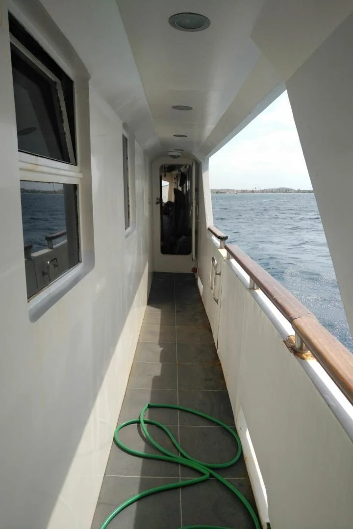 a long hallway with a railing aboard STAR ALLIANCE Yacht for Sale
