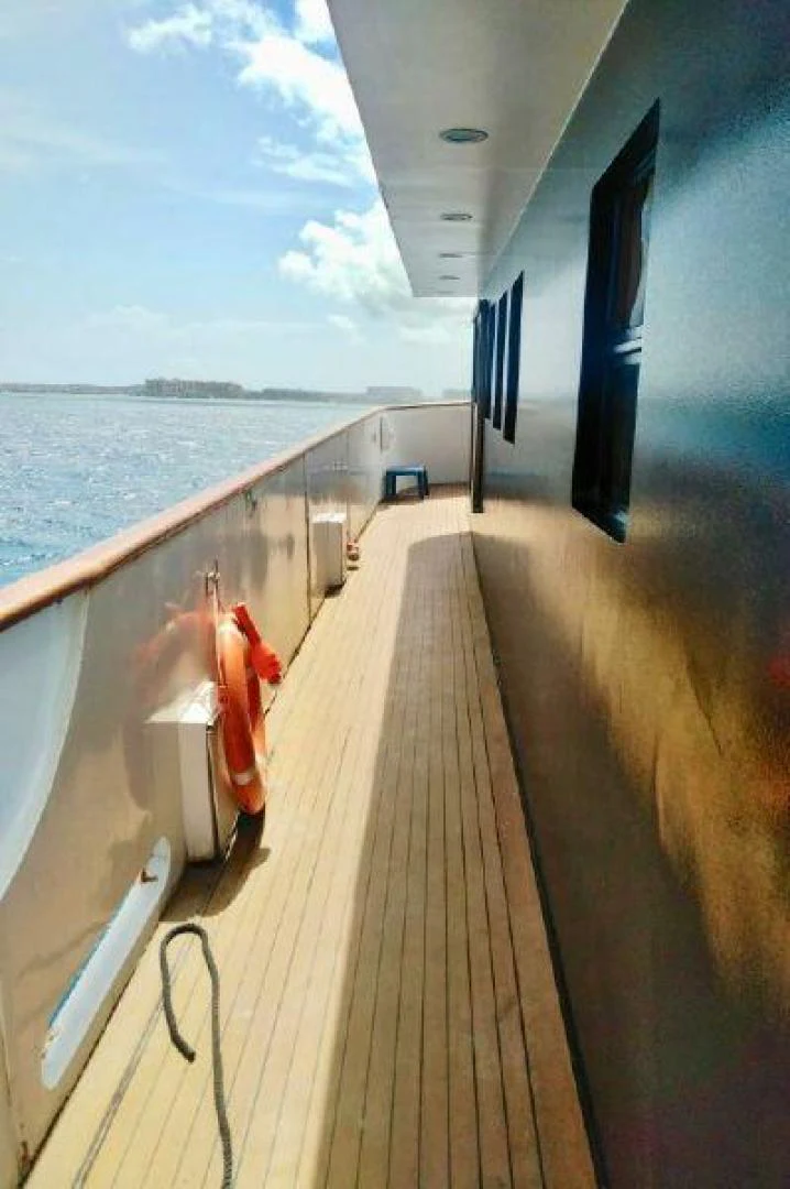 a person standing on a boat aboard STAR ALLIANCE Yacht for Sale