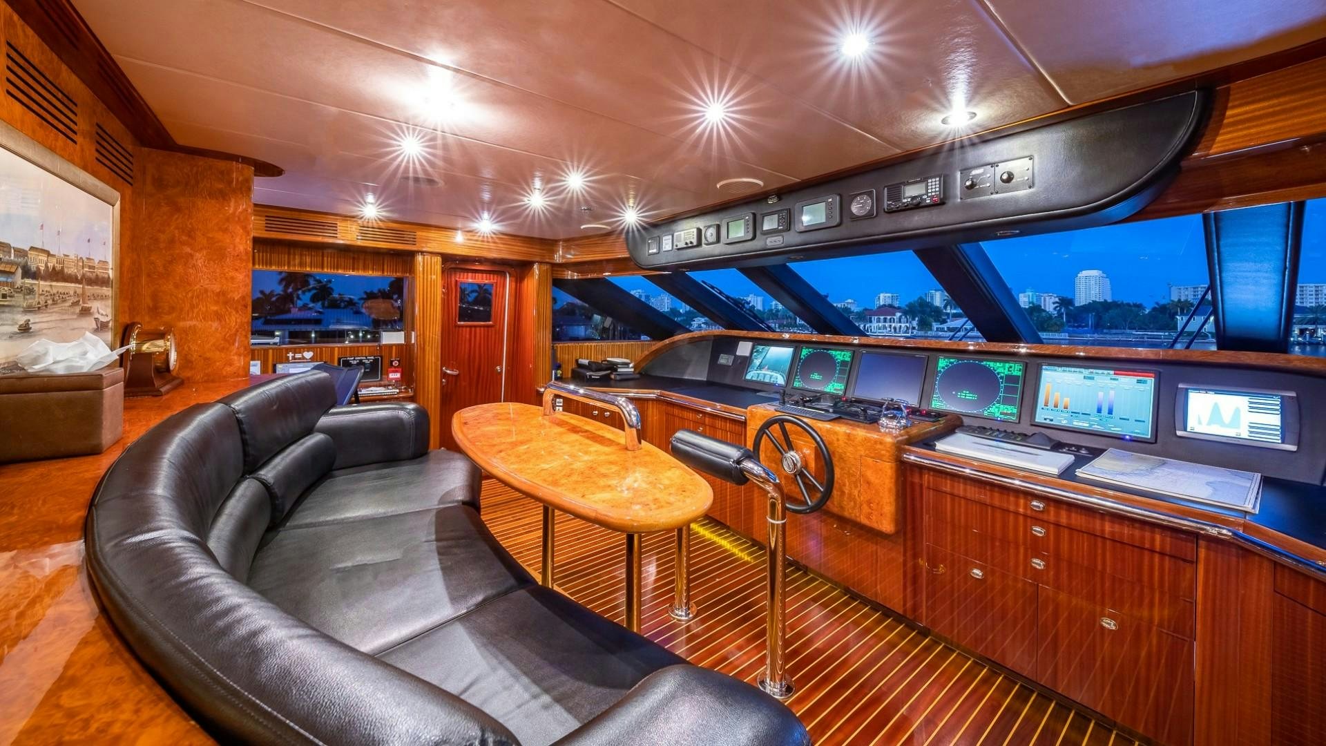 a room with a couch and a tv in it aboard LADY LEILA Yacht for Sale