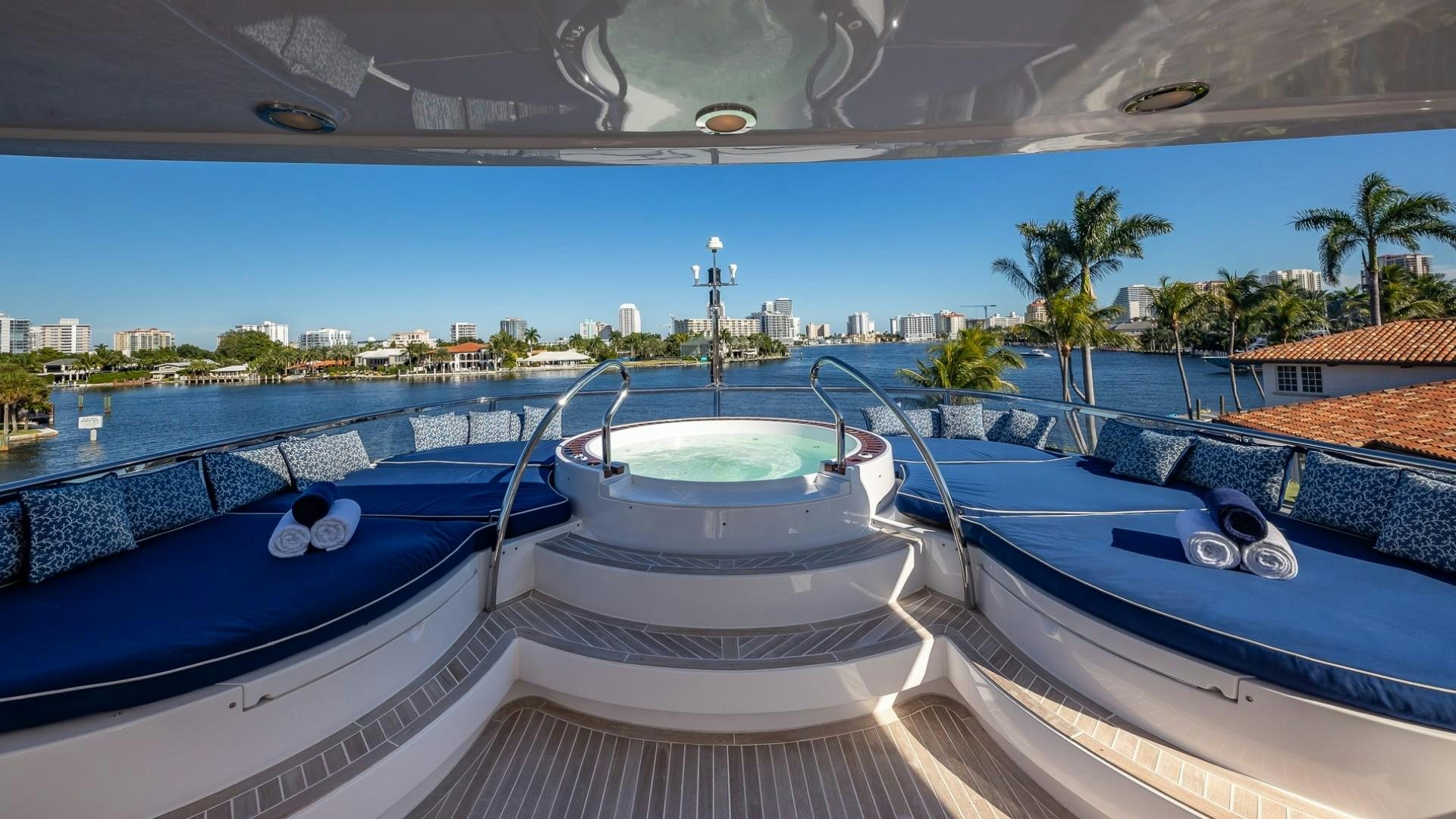 a pool with a deck and a city in the background aboard LADY LEILA Yacht for Sale
