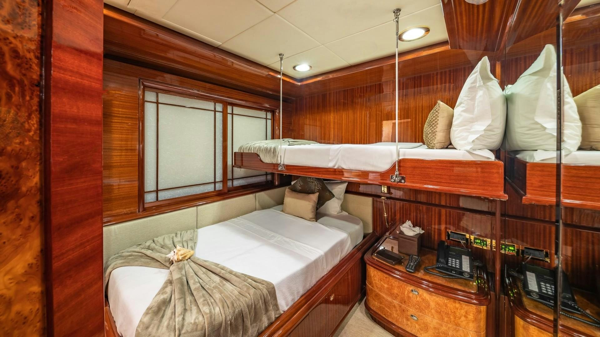 a bed with a white sheet on it aboard LADY LEILA Yacht for Sale