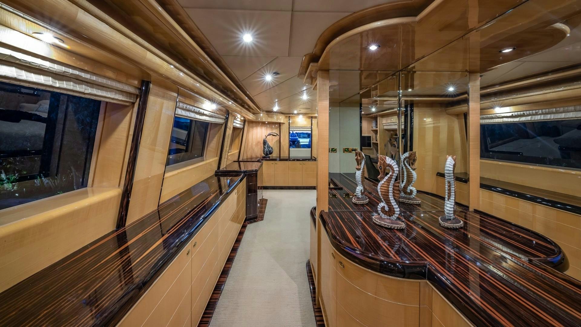 a long hallway with a glass wall aboard LADY LEILA Yacht for Sale