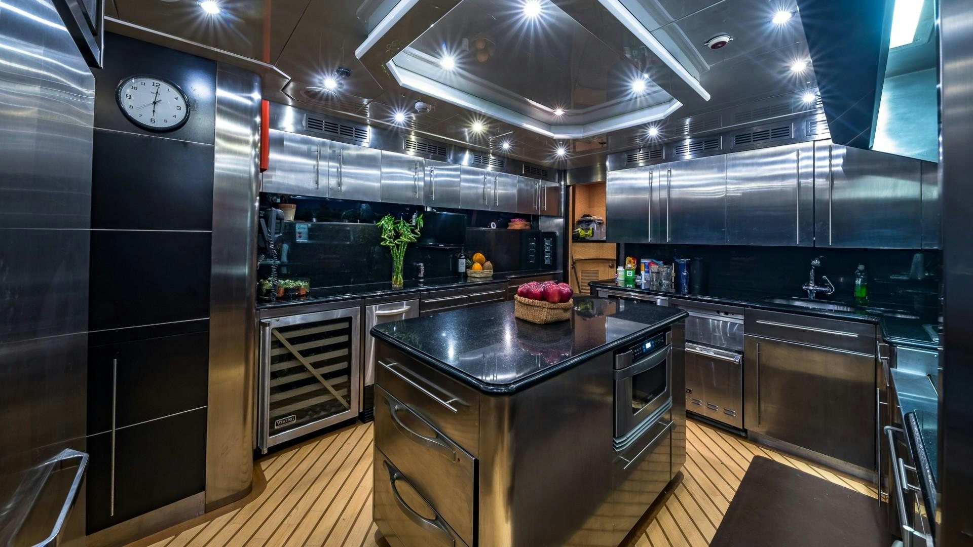 a kitchen with black cabinets aboard LADY LEILA Yacht for Sale