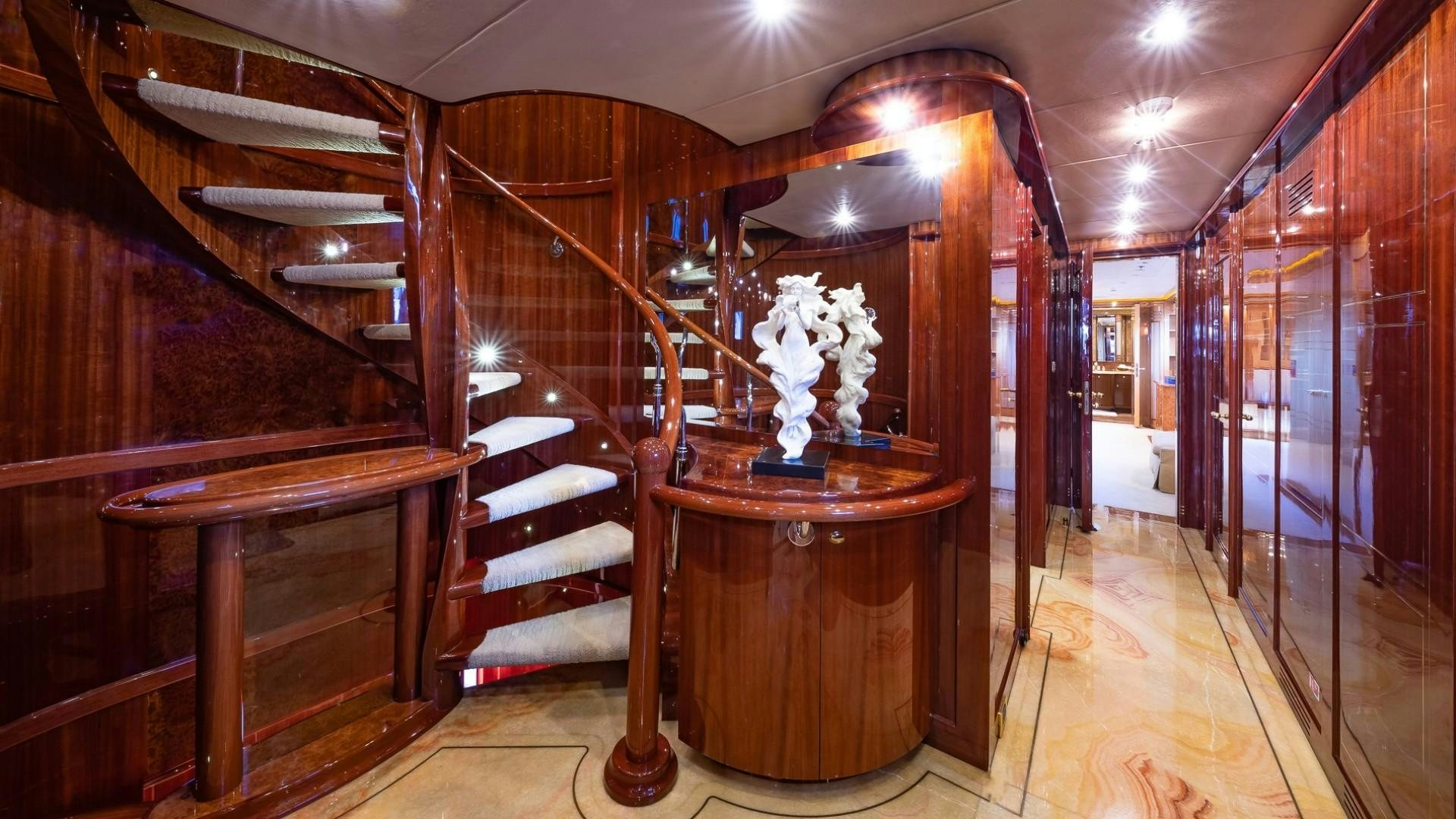a room with wooden furniture aboard LADY LEILA Yacht for Sale