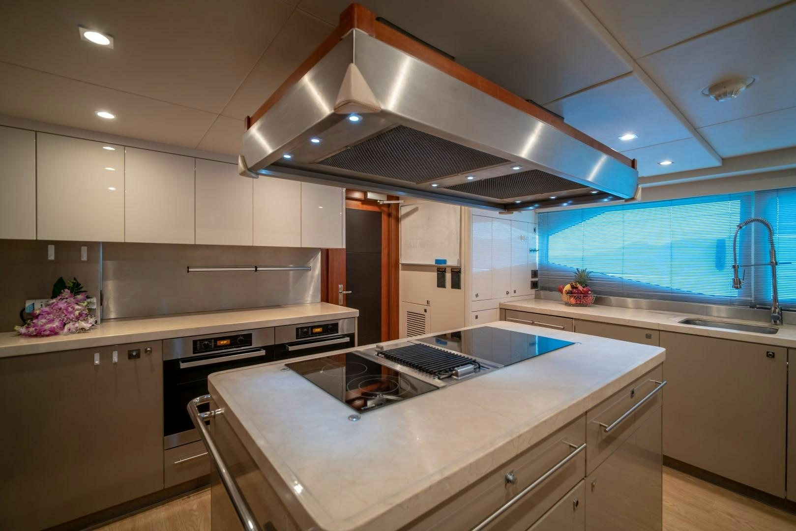 a kitchen with a large island aboard ABOUT TIME Yacht for Sale