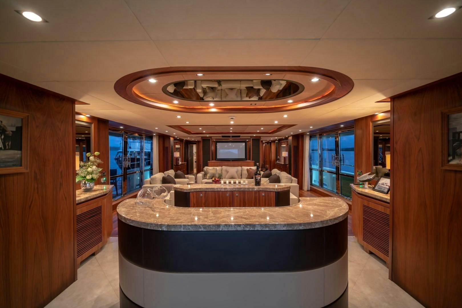 a large room with a large round table and a large chandelier aboard ABOUT TIME Yacht for Sale