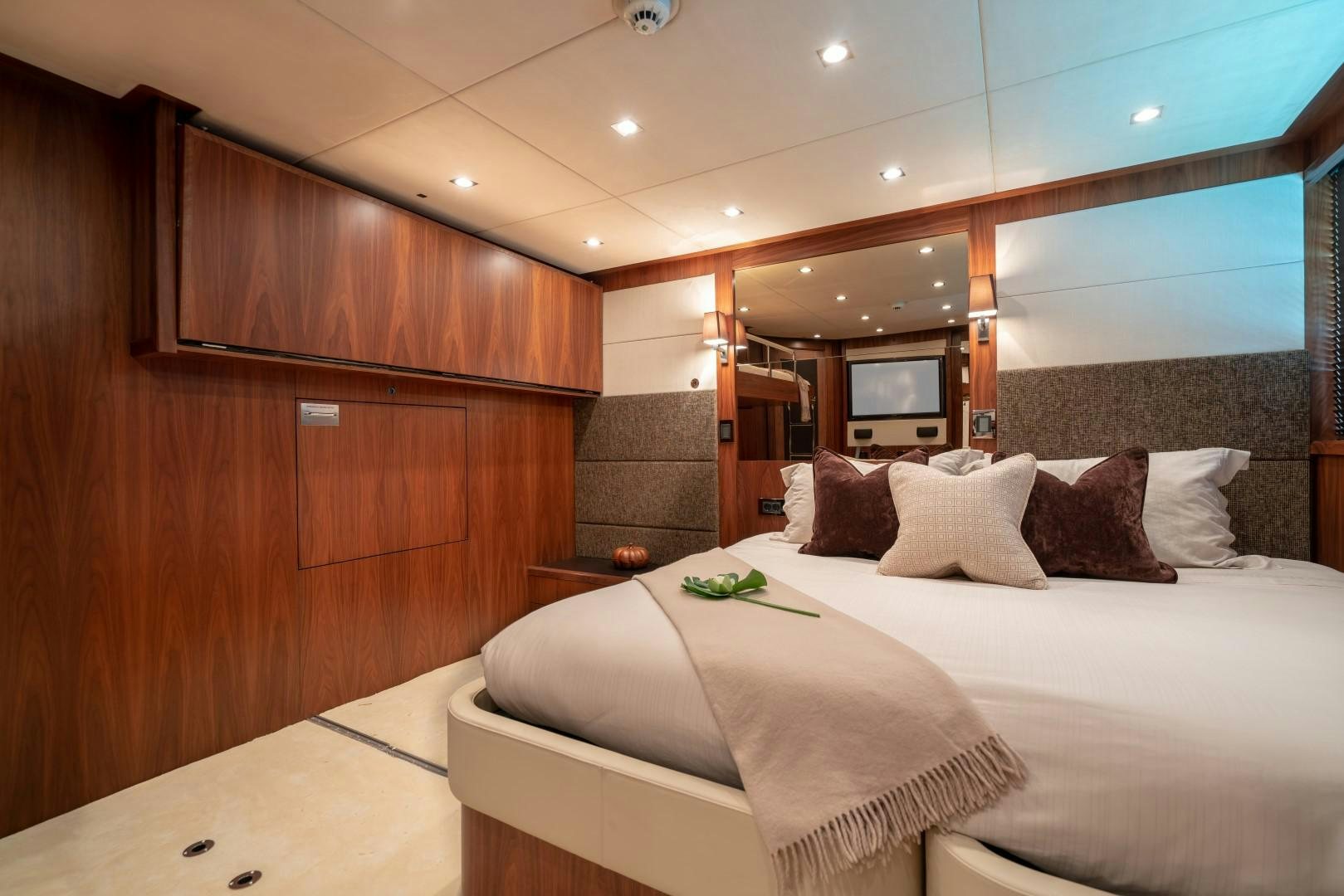 a room with a bed and a mirror aboard ABOUT TIME Yacht for Sale