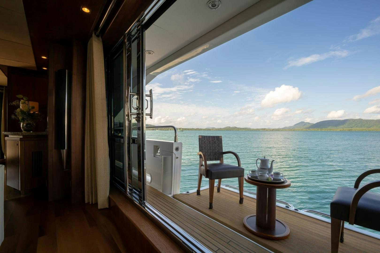 a room with a view of the water and the land below aboard ABOUT TIME Yacht for Sale