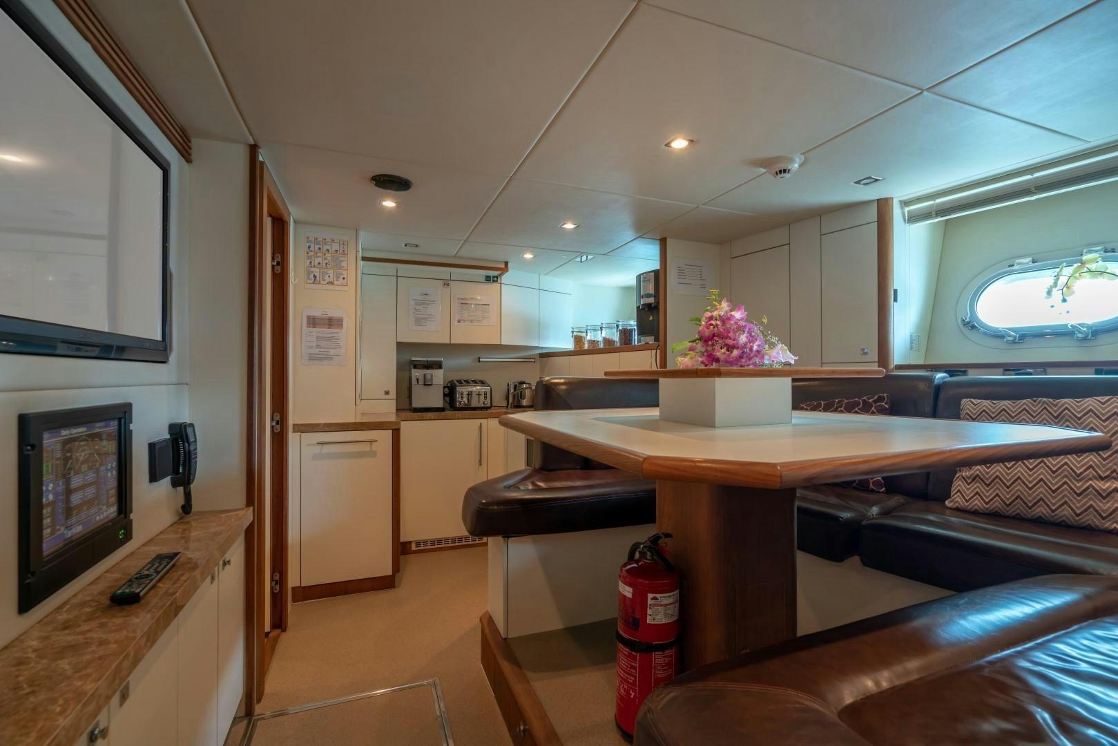a kitchen with a table and chairs aboard ABOUT TIME Yacht for Sale