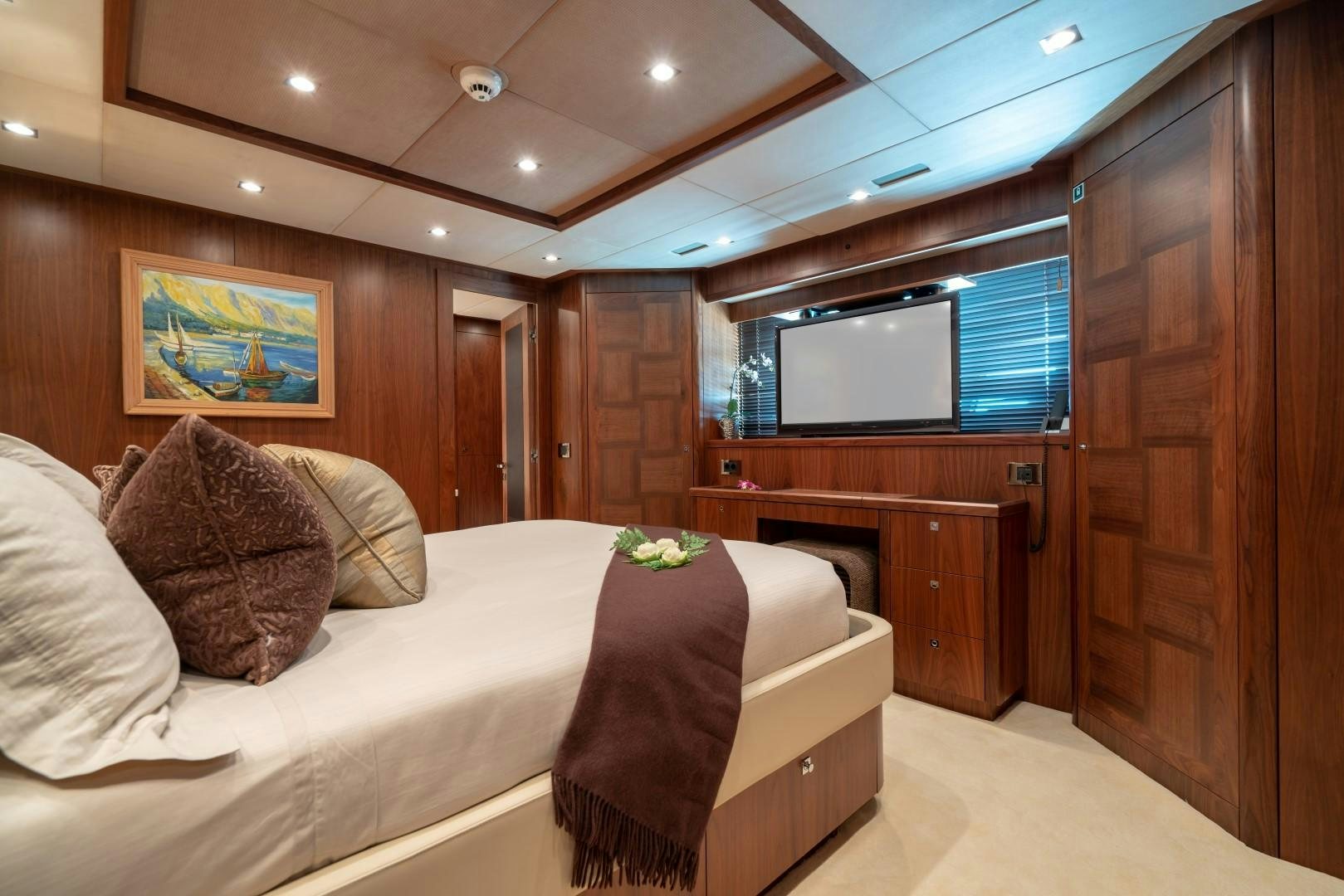 a bedroom with a bed and a television aboard ABOUT TIME Yacht for Sale