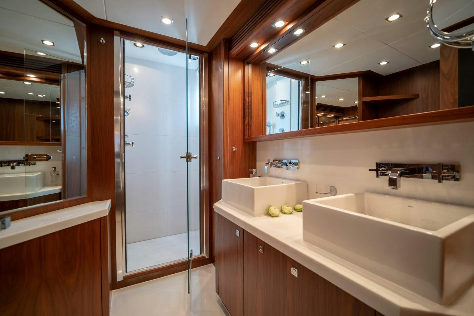 a bathroom with a glass shower aboard ABOUT TIME Yacht for Sale