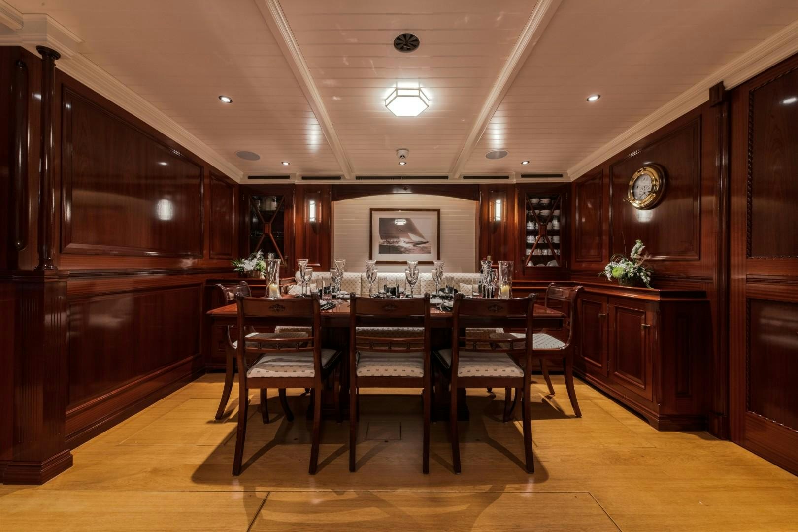 a dining room with a table and chairs aboard RAINBOW Yacht for Sale