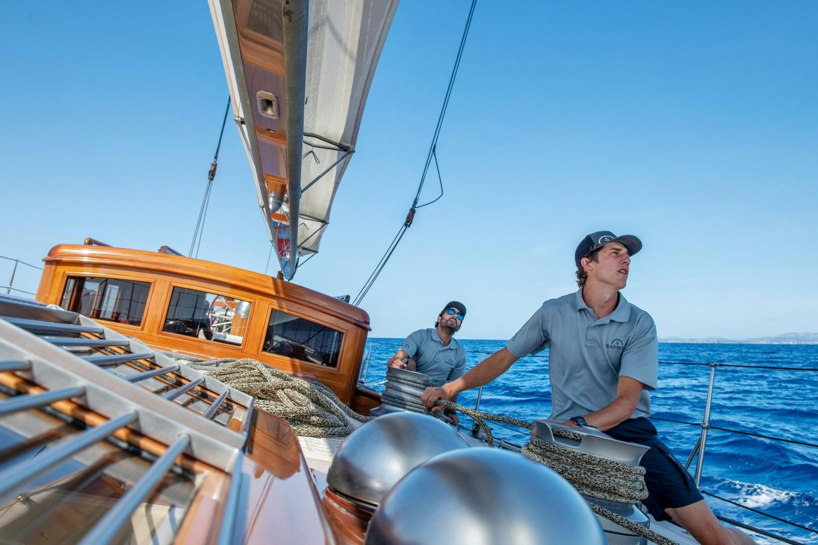 a group of men on a boat aboard RAINBOW Yacht for Sale