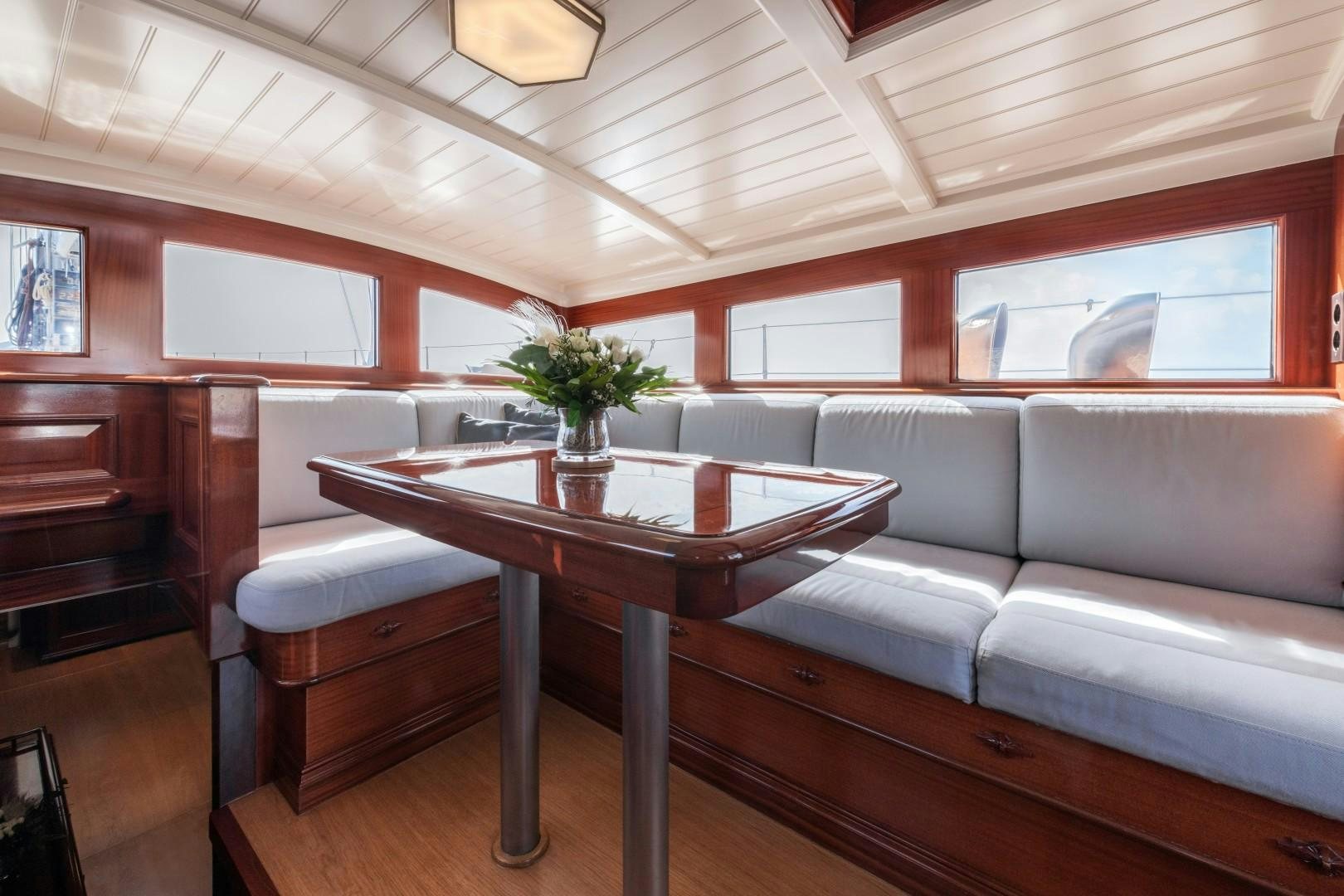 a living room with a couch and a coffee table aboard RAINBOW Yacht for Sale