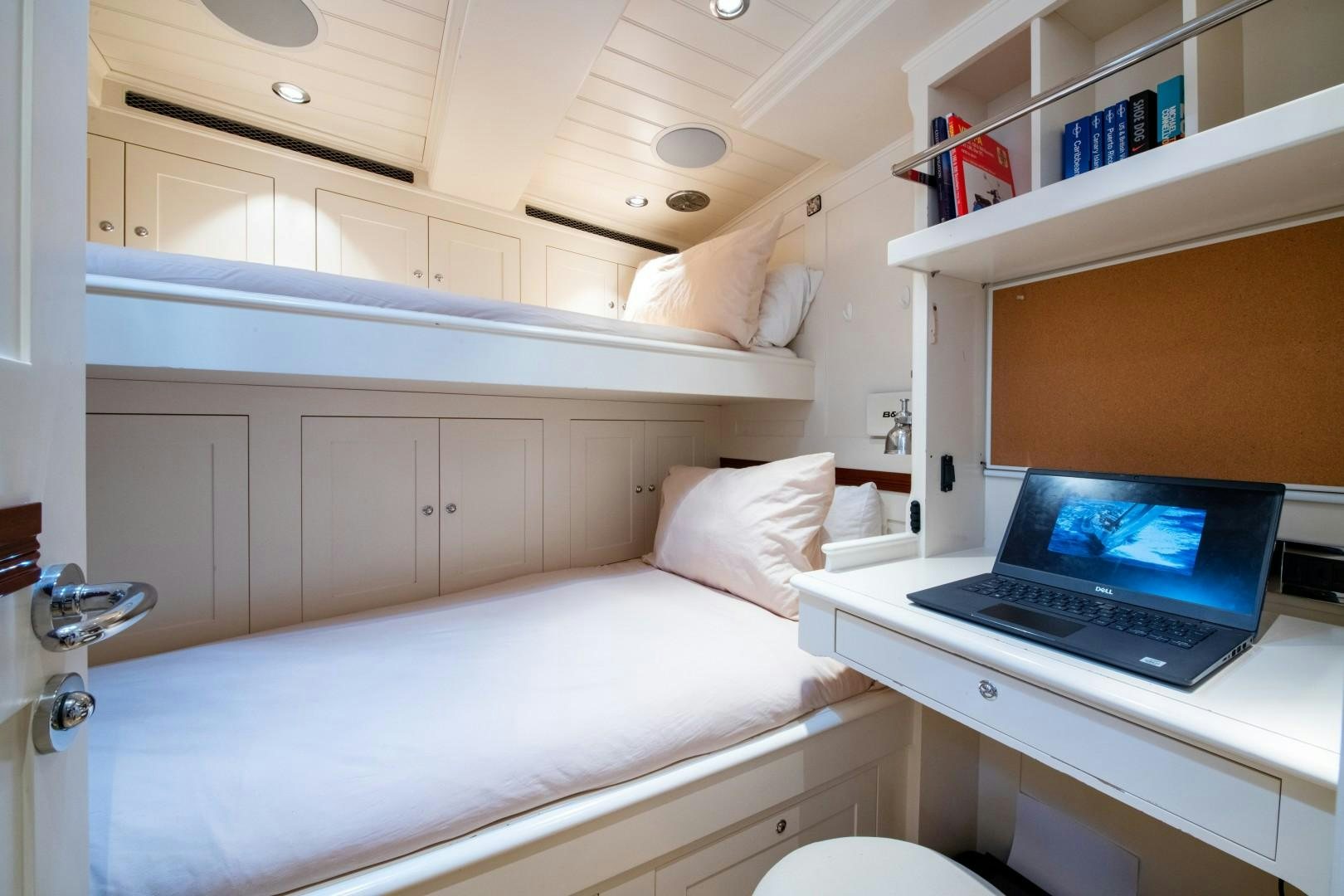 a bed with a laptop on it aboard RAINBOW Yacht for Sale