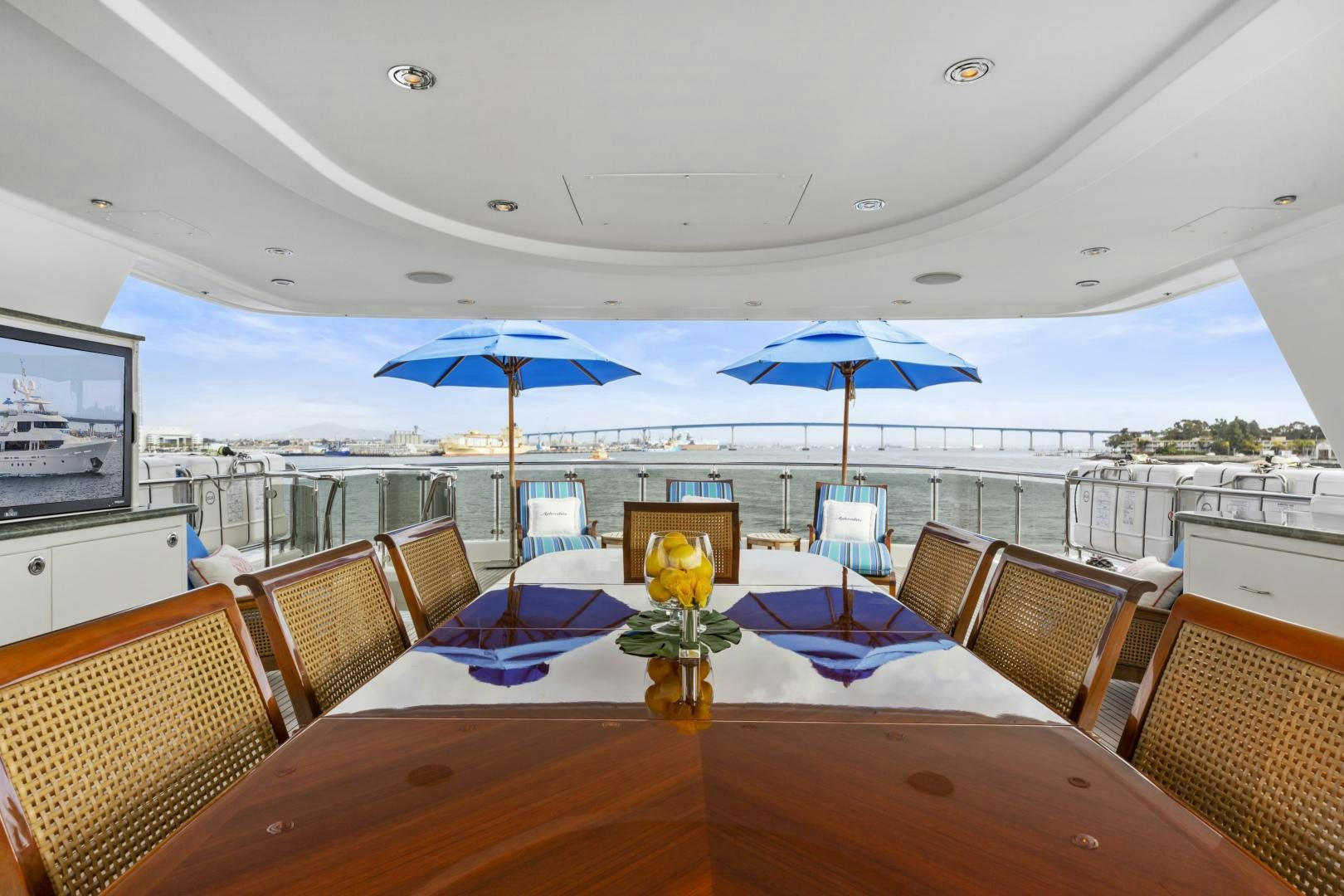 a table with chairs and umbrellas on it aboard APHRODITE Yacht for Sale