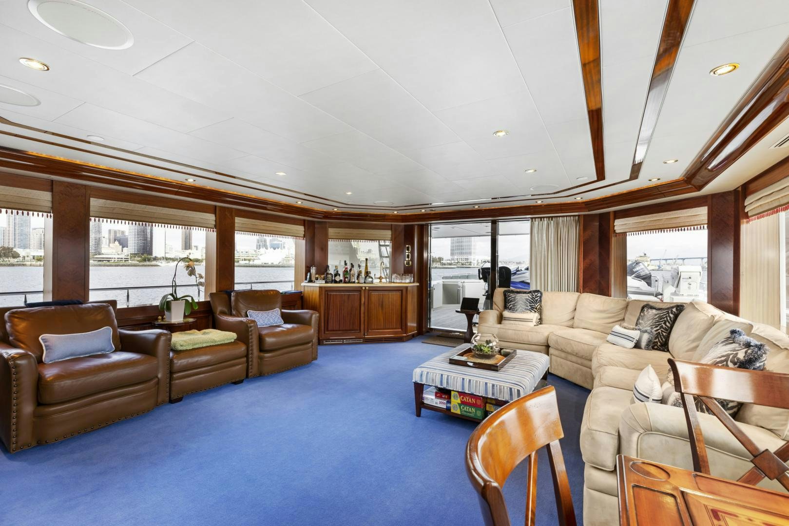 a living room with a blue rug aboard APHRODITE Yacht for Sale