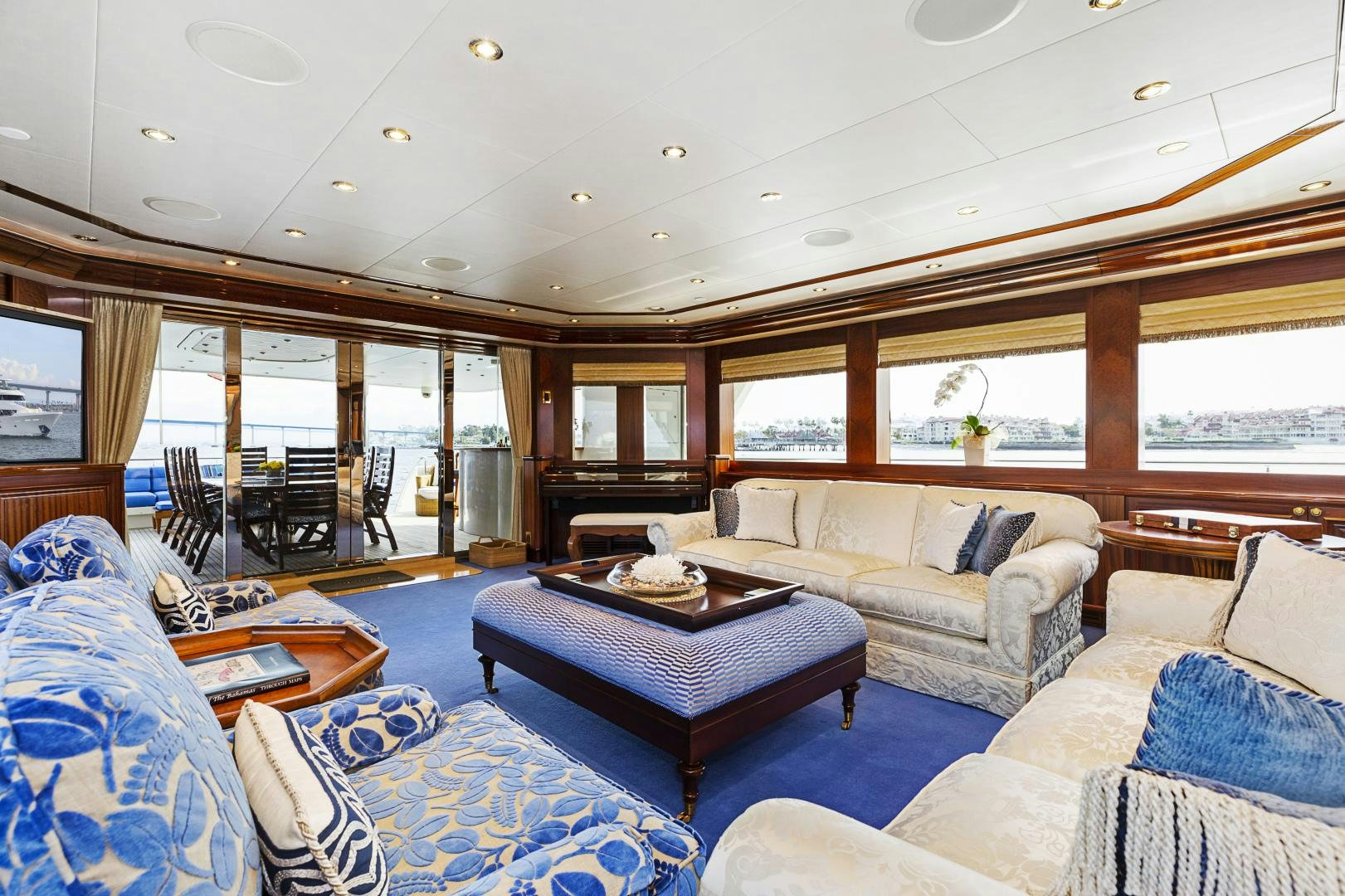 a living room with a table and couches aboard APHRODITE Yacht for Sale