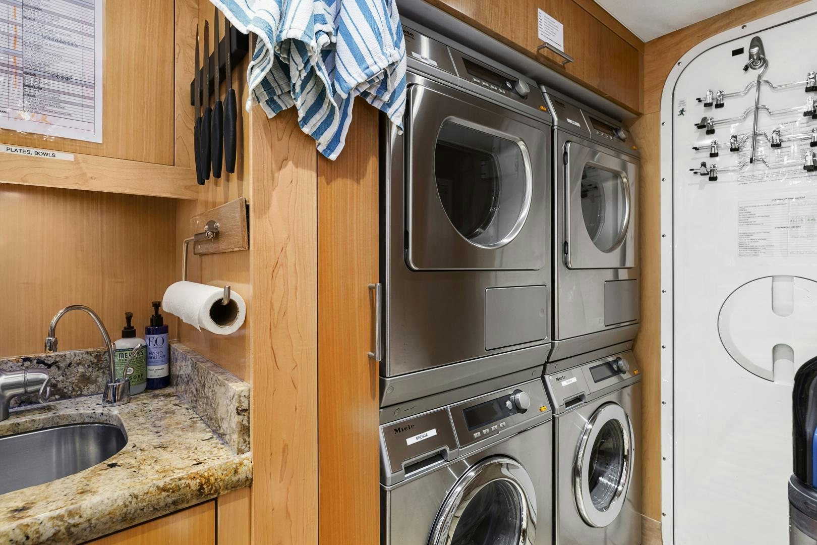 a kitchen with a washing machine and sink aboard APHRODITE Yacht for Sale