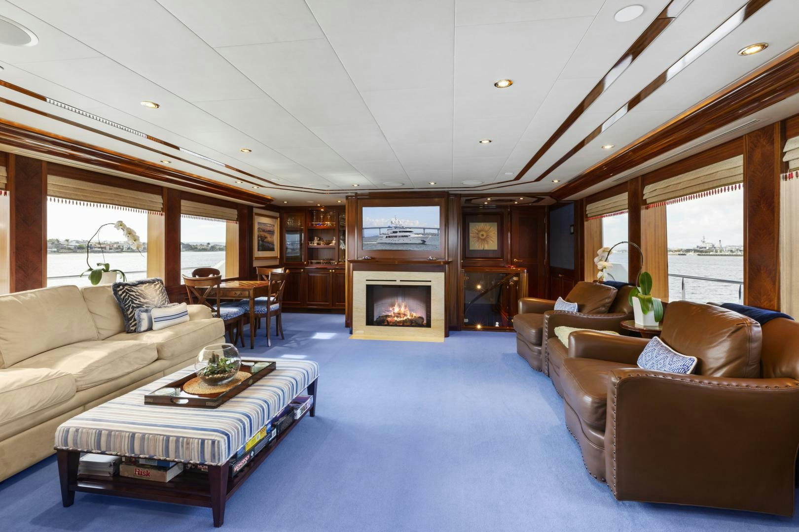 a living room with a fireplace aboard APHRODITE Yacht for Sale