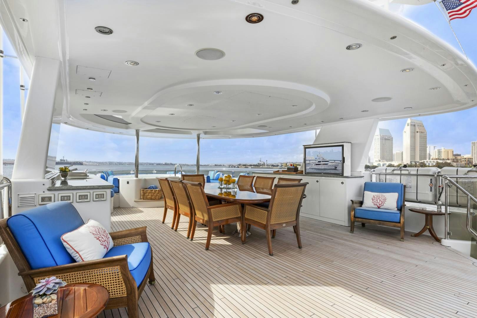 a room with a table chairs and a view of the city aboard APHRODITE Yacht for Sale