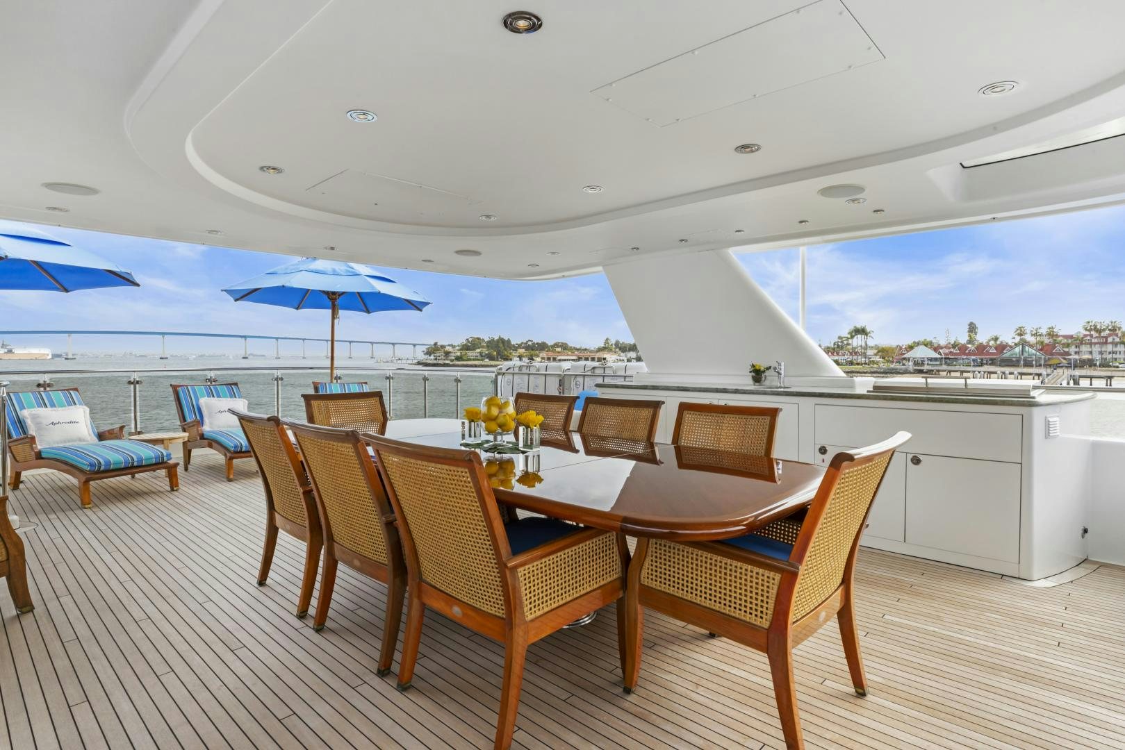 a dining room with chairs and umbrellas aboard APHRODITE Yacht for Sale