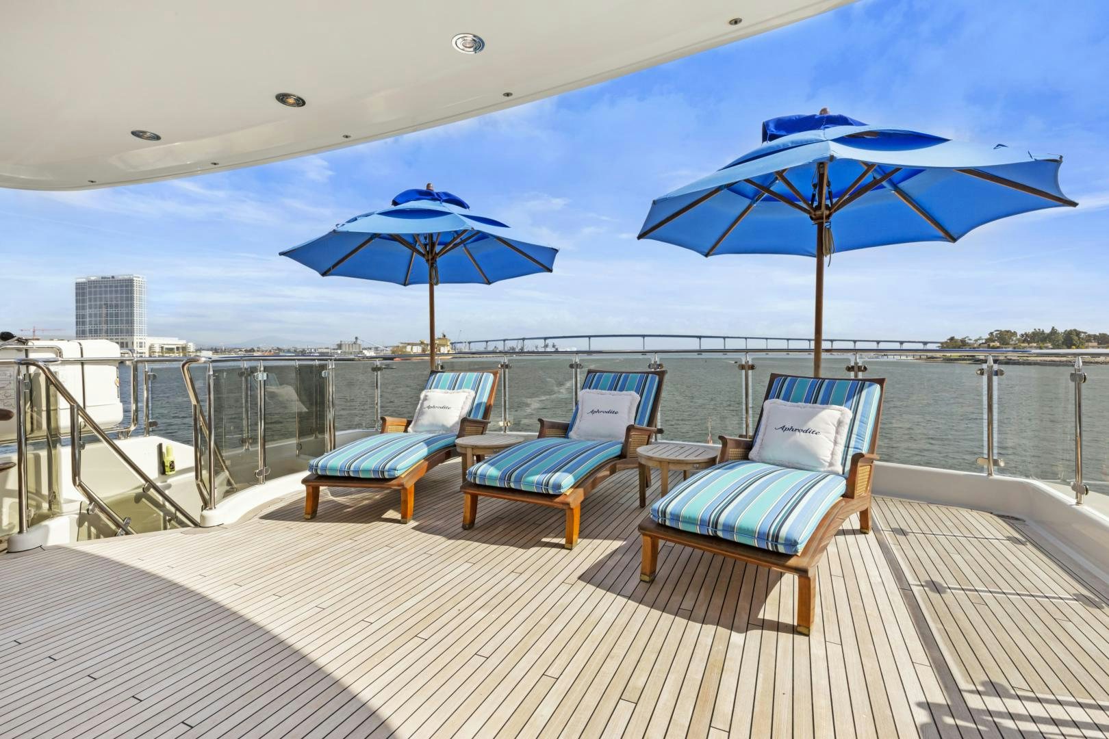 a deck with chairs and umbrellas aboard APHRODITE Yacht for Sale