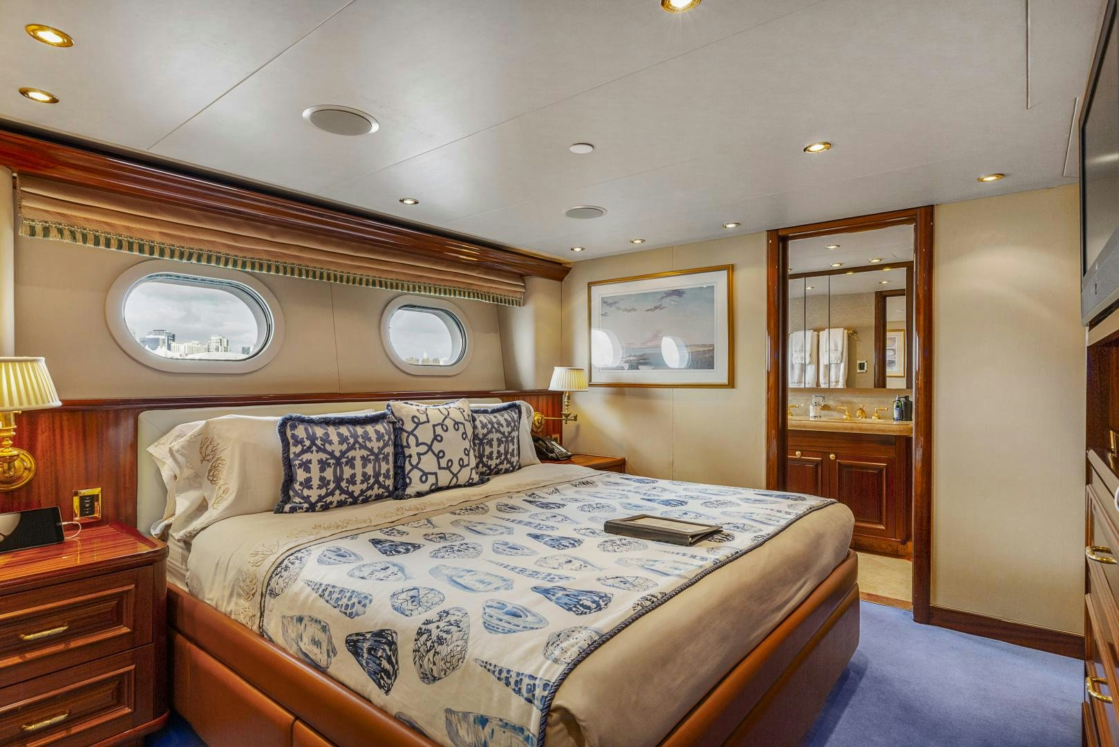 a bedroom with a bed and a mirror aboard APHRODITE Yacht for Sale