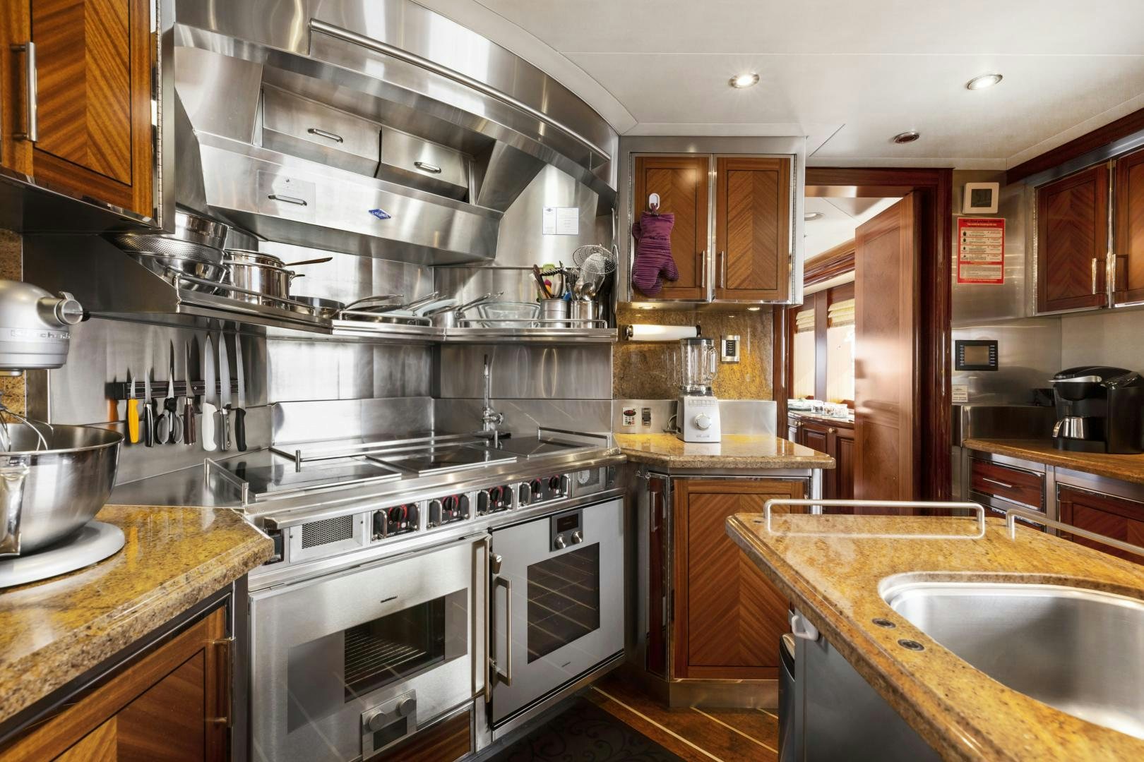 a kitchen with stainless steel appliances aboard APHRODITE Yacht for Sale