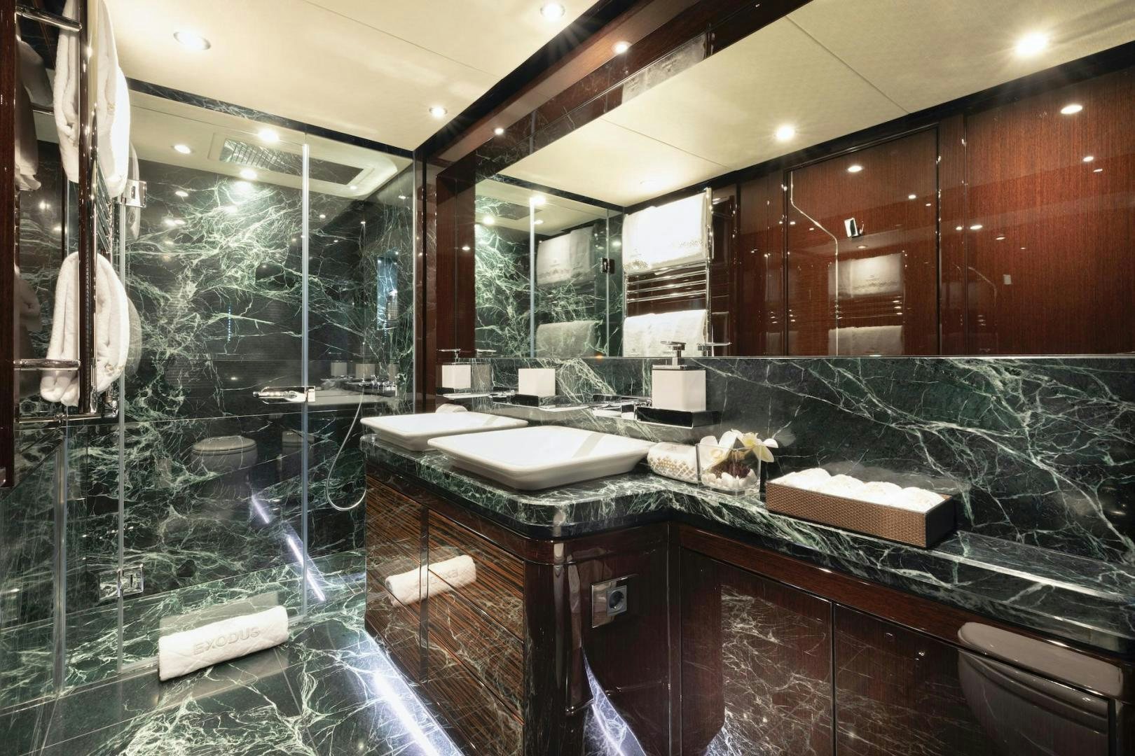 a bathroom with a large glass shower aboard EXODUS Yacht for Sale