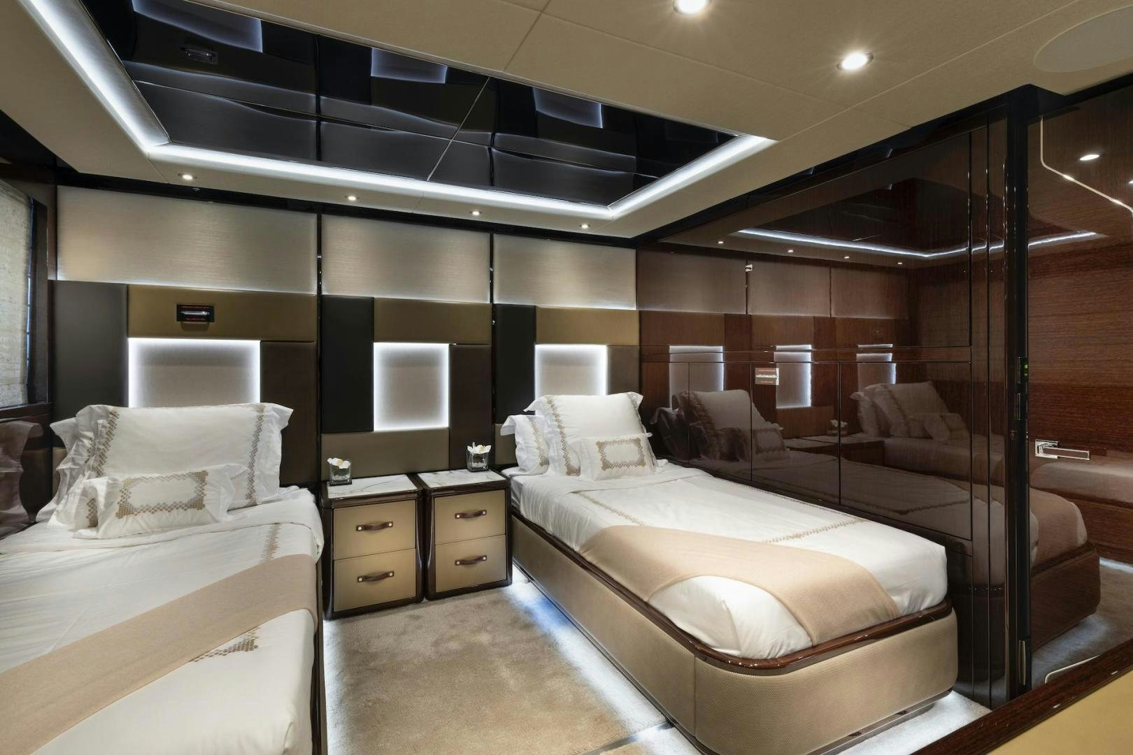 a room with a bed and a couch aboard EXODUS Yacht for Sale