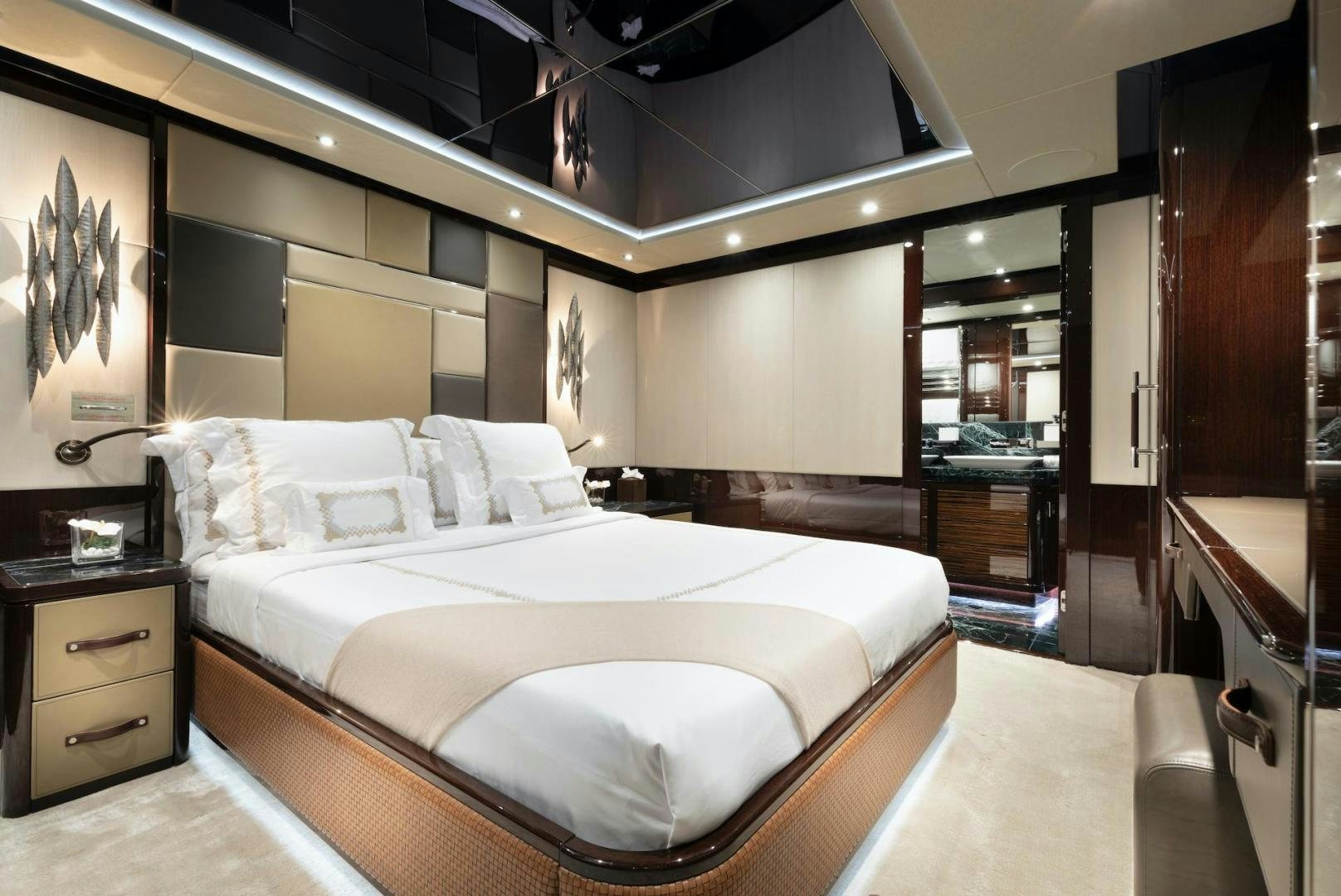 a bedroom with a bed and a mirror aboard EXODUS Yacht for Sale