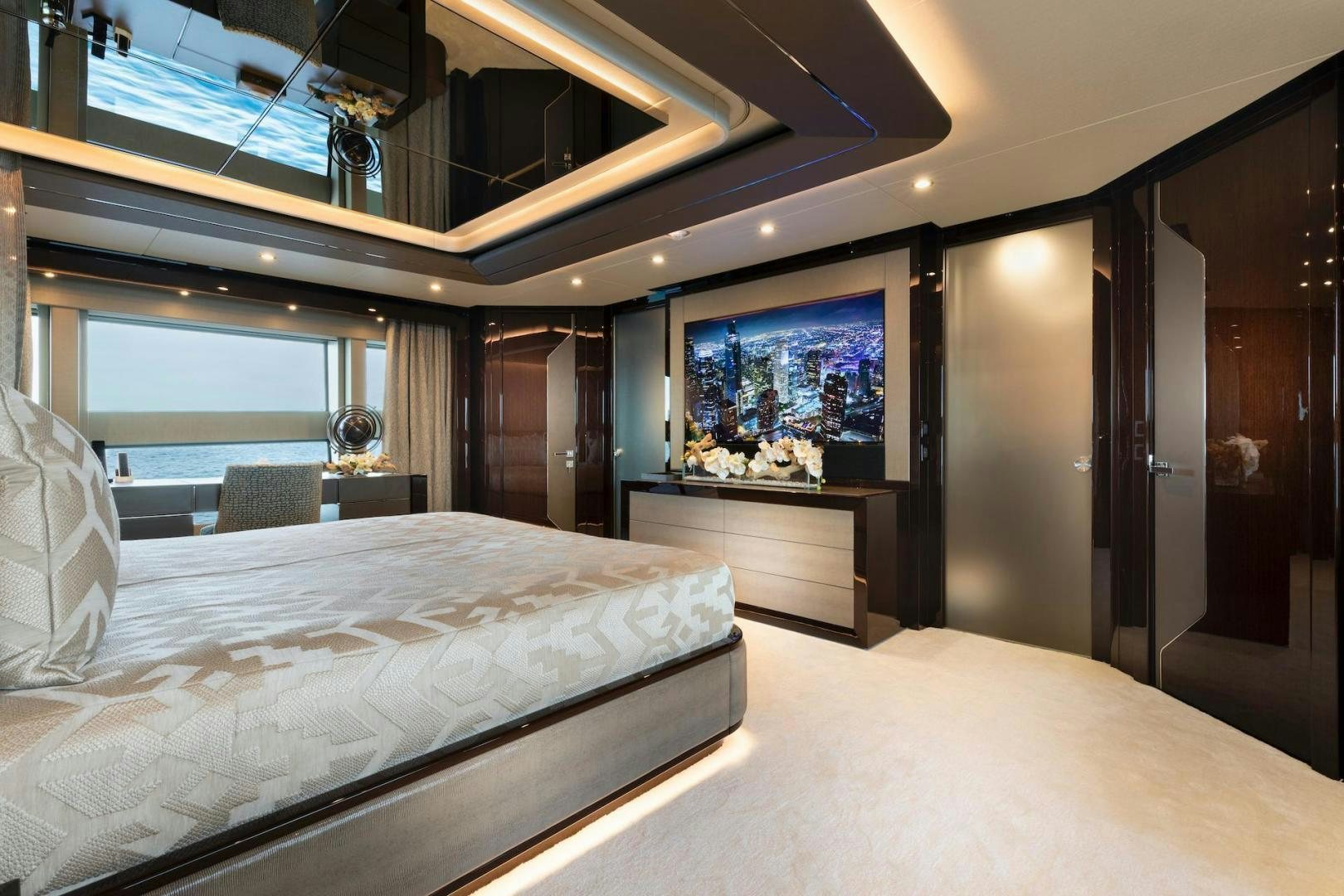 a room with a bed and a television aboard EXODUS Yacht for Sale