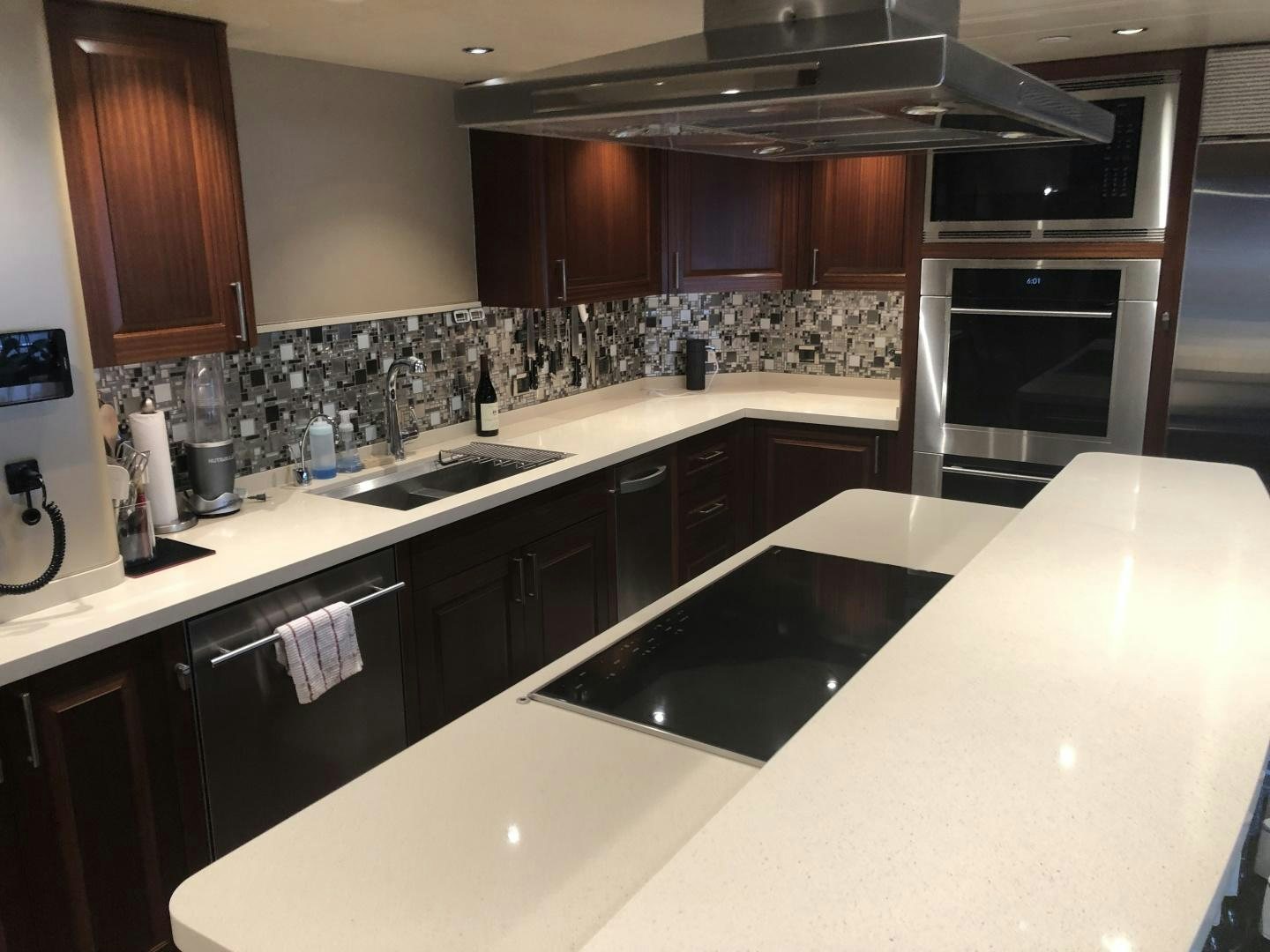 a kitchen with black appliances aboard ARMS REACH Yacht for Sale