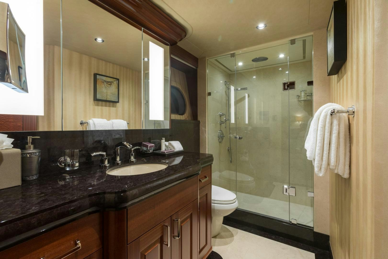 a bathroom with a glass shower door aboard ARMS REACH Yacht for Sale